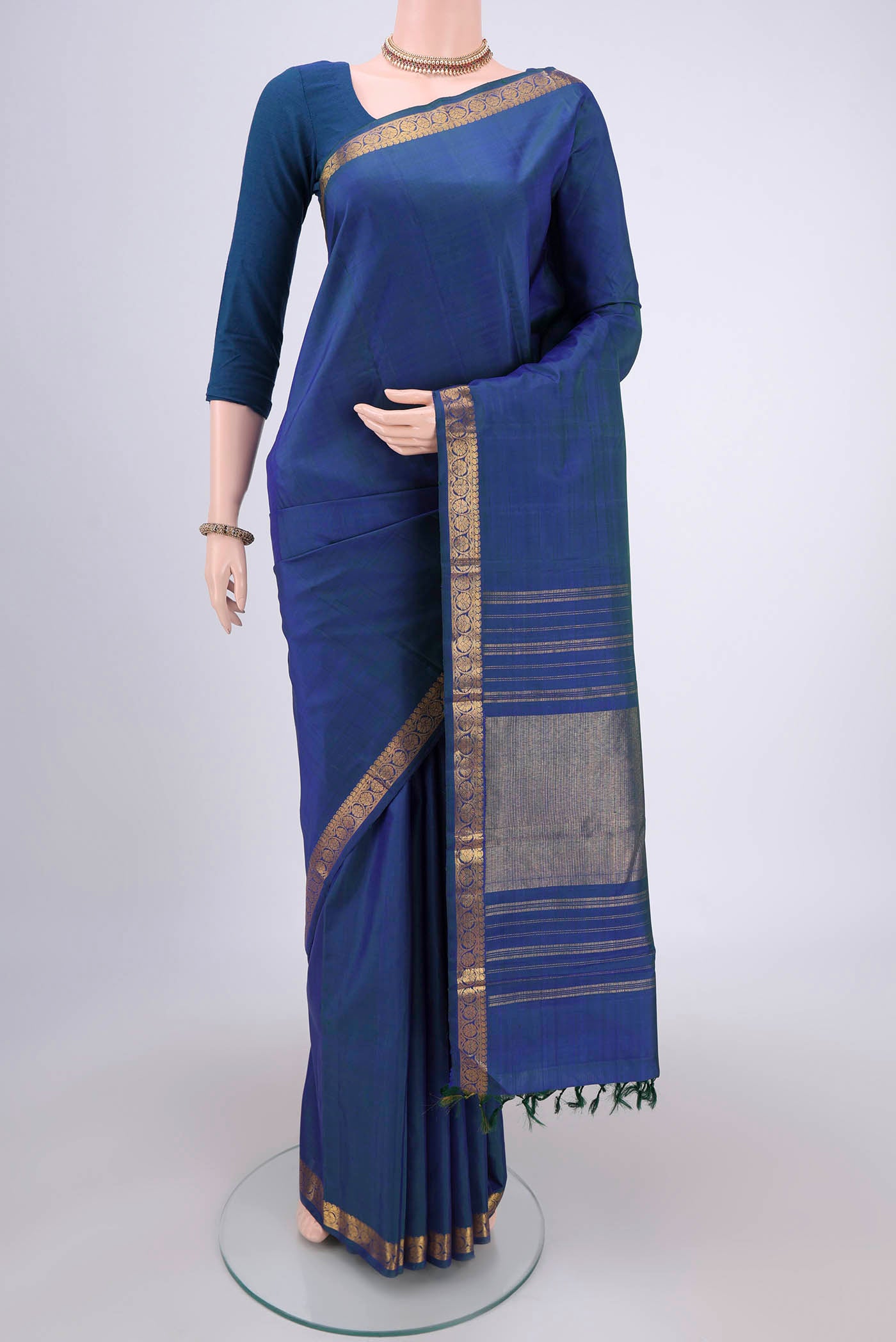 Peacock Blue Dual Tone Kanjivaram Silk Saree with Plain Body and Zari Border.  displayed on a mannequin