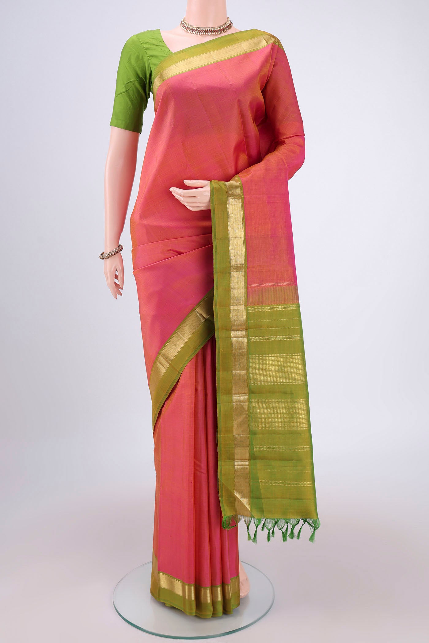 Brick Orange Dual Tone Kanjivaram Silk Saree with Plain Body and Zari Border.  displayed on a mannequin