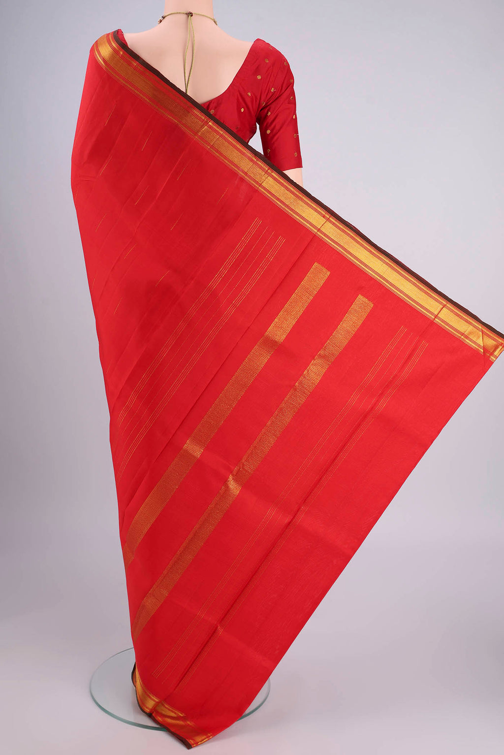 Flat view of Red Kanchipuram Silk Saree with Zari Butta on the body and Zari Border. 