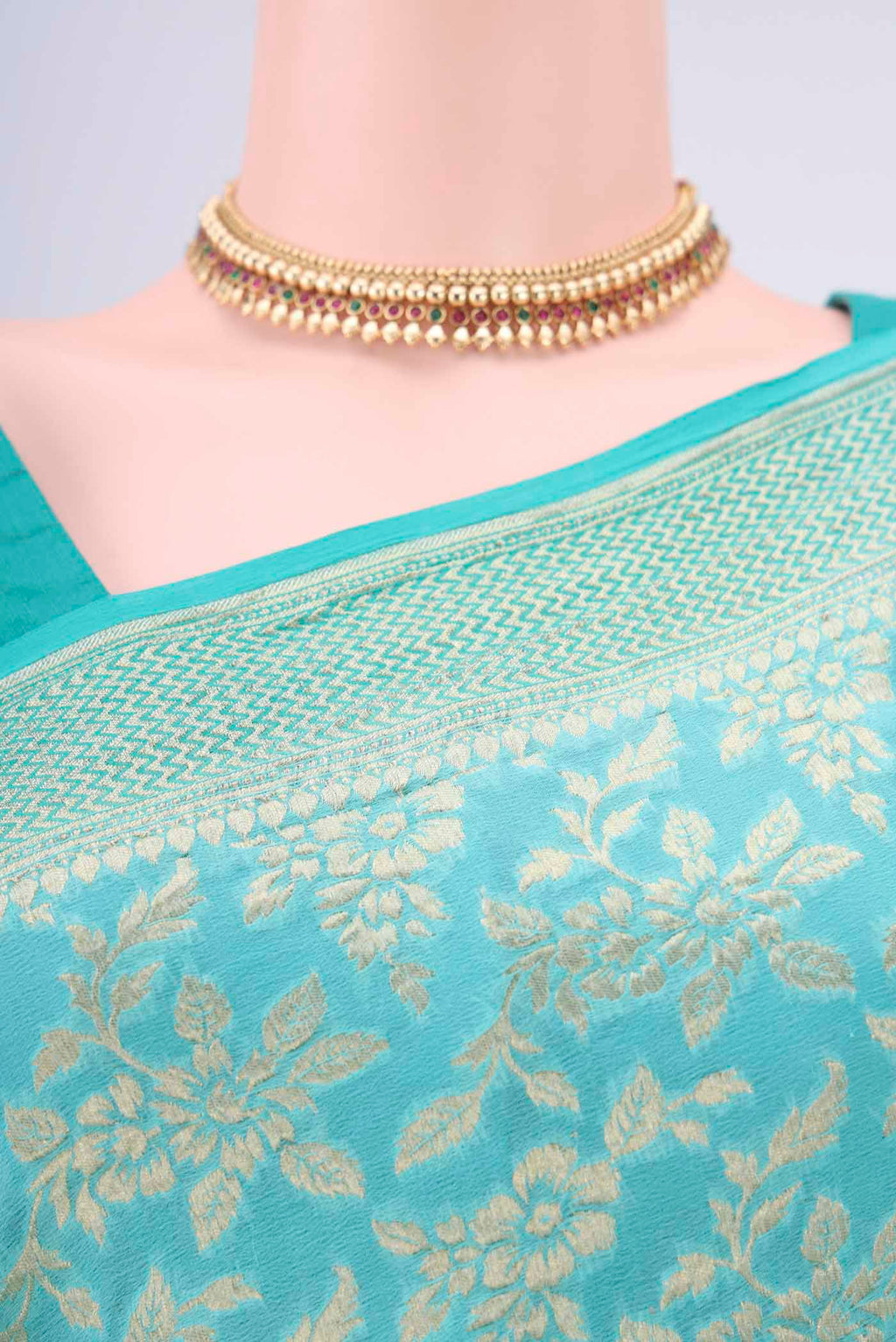 Border image of Turquoise Banarasi Georgette Saree with Zari Brocade on the body and Zari Border. 
