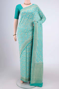 Turquoise Banarasi Georgette Saree with Zari Brocade on the body and Zari Border.  displayed on a mannequin