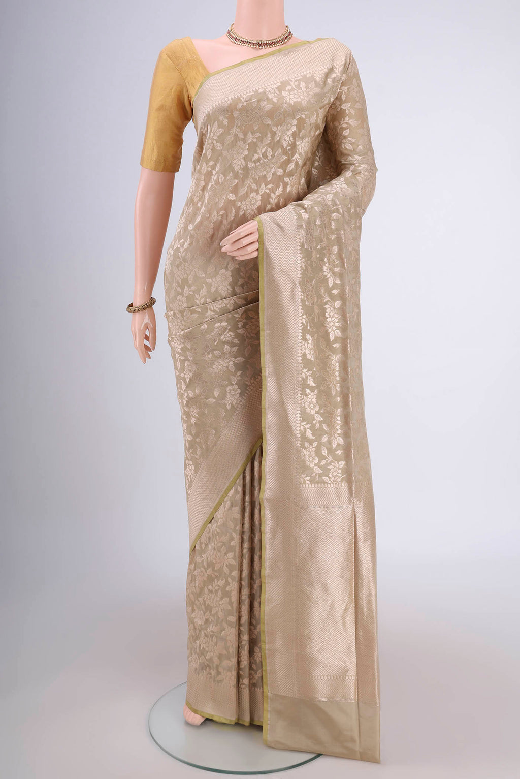 Acid Green Banarasi Silk Saree with Zari Brocade on the body and Zari Border.  displayed on a mannequin