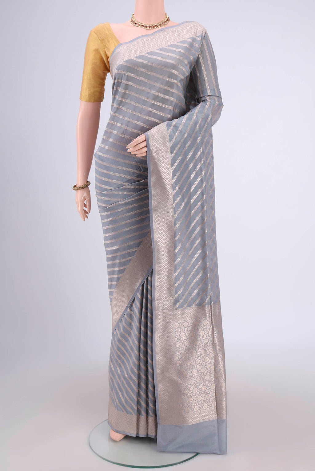 Blue Grey Banarasi Silk Saree with Stripes on the body and Zari Border.  displayed on a mannequin