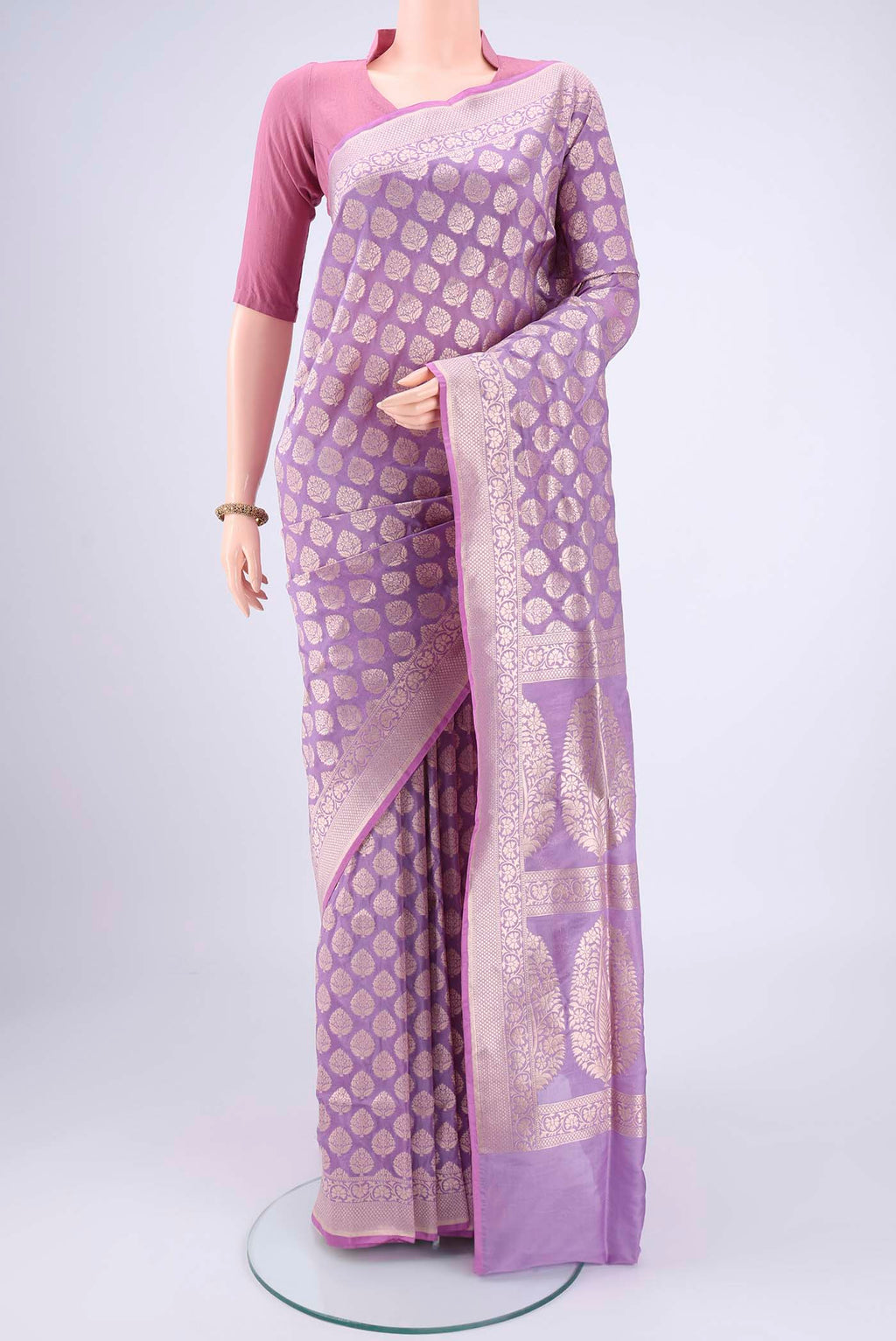 Lavender Banarasi Silk Saree with Zari Butta on the body and Zari Border.  displayed on a mannequin