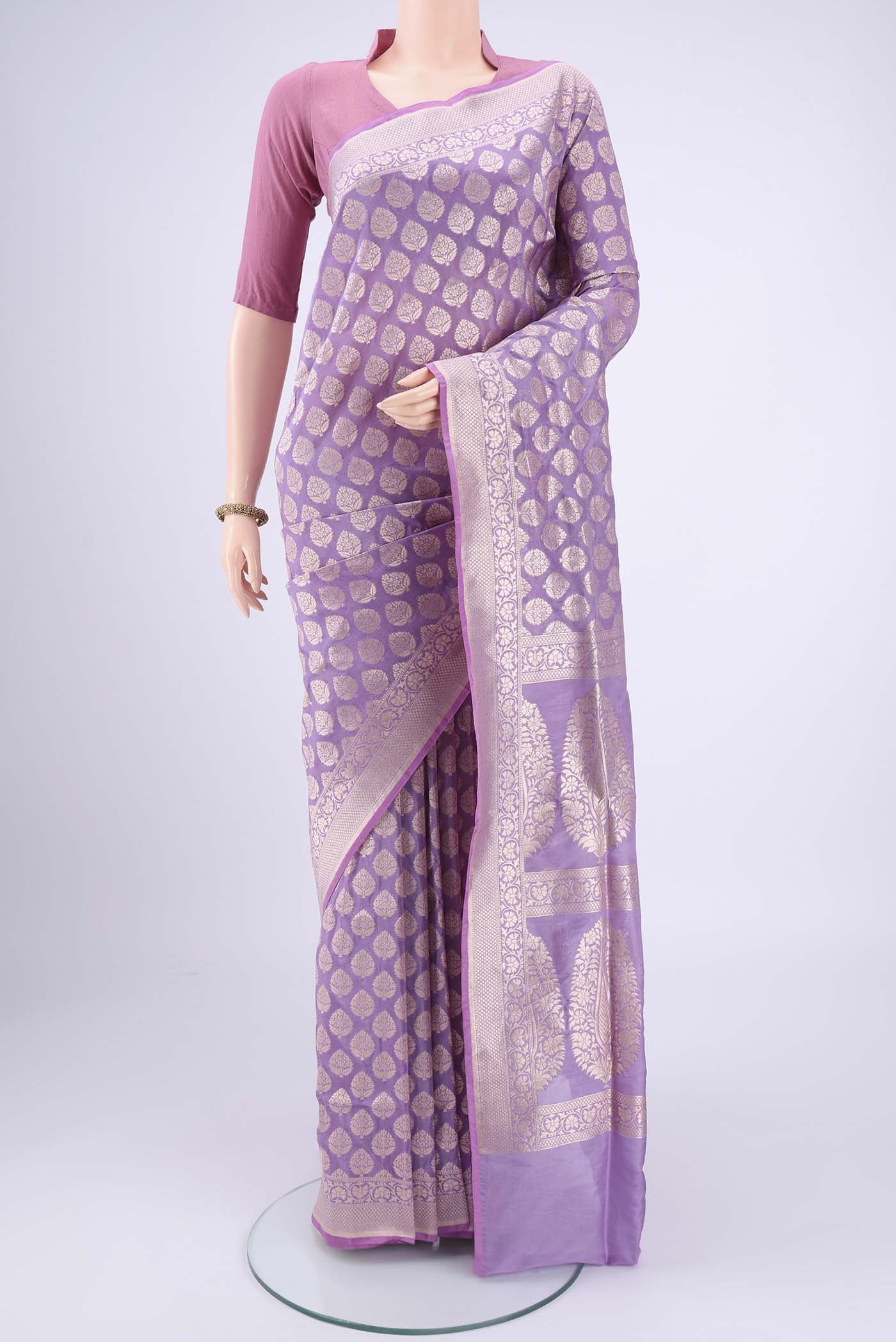 Lavender Banarasi Silk Saree with Zari Butta on the body and Zari Border.  displayed on a mannequin