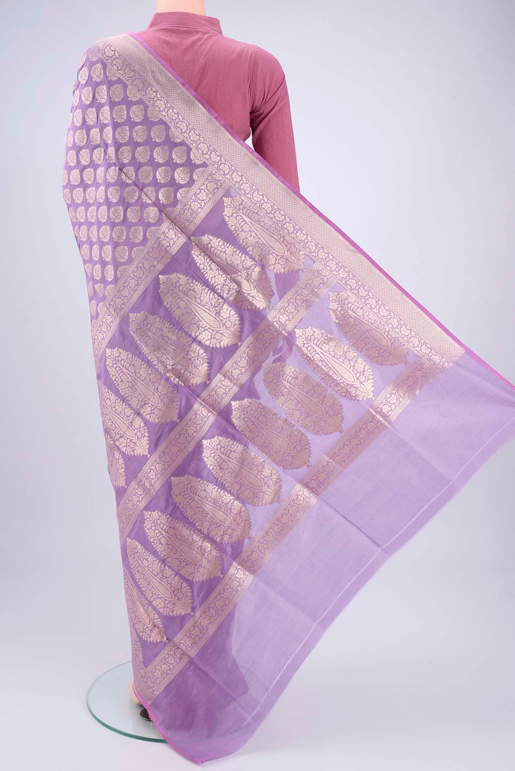 Flat view of Lavender Banarasi Silk Saree with Zari Butta on the body and Zari Border. 