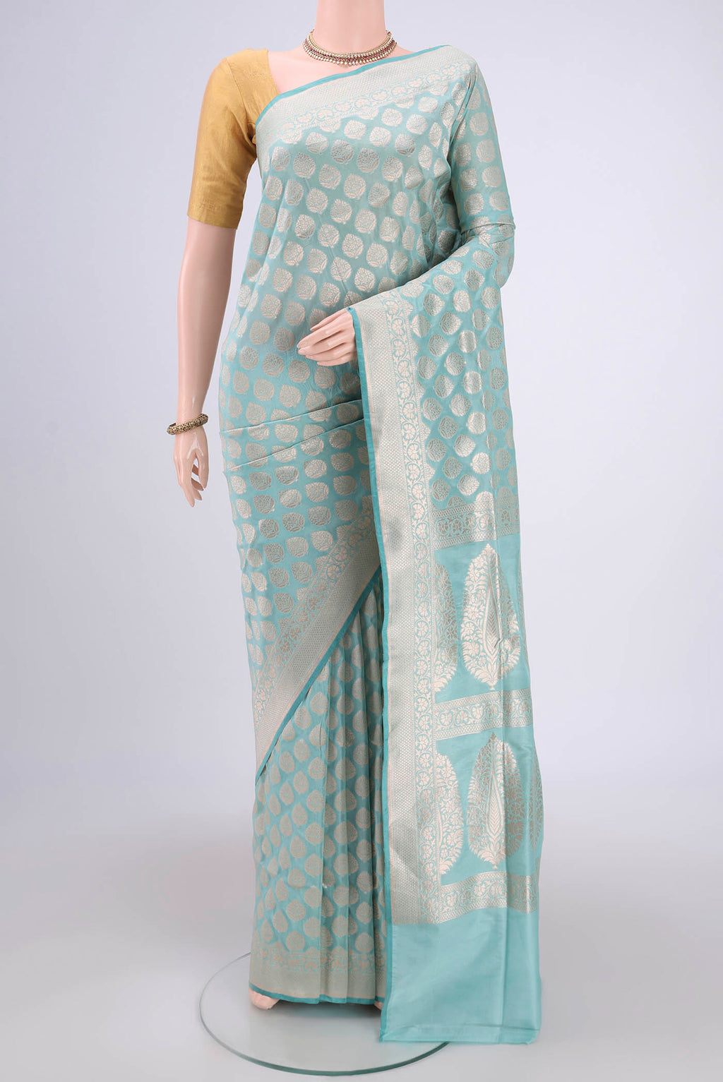 Sea Green Dual Tone Banarasi Silk Saree with Zari Butta on the body and Zari Border.  displayed on a mannequin