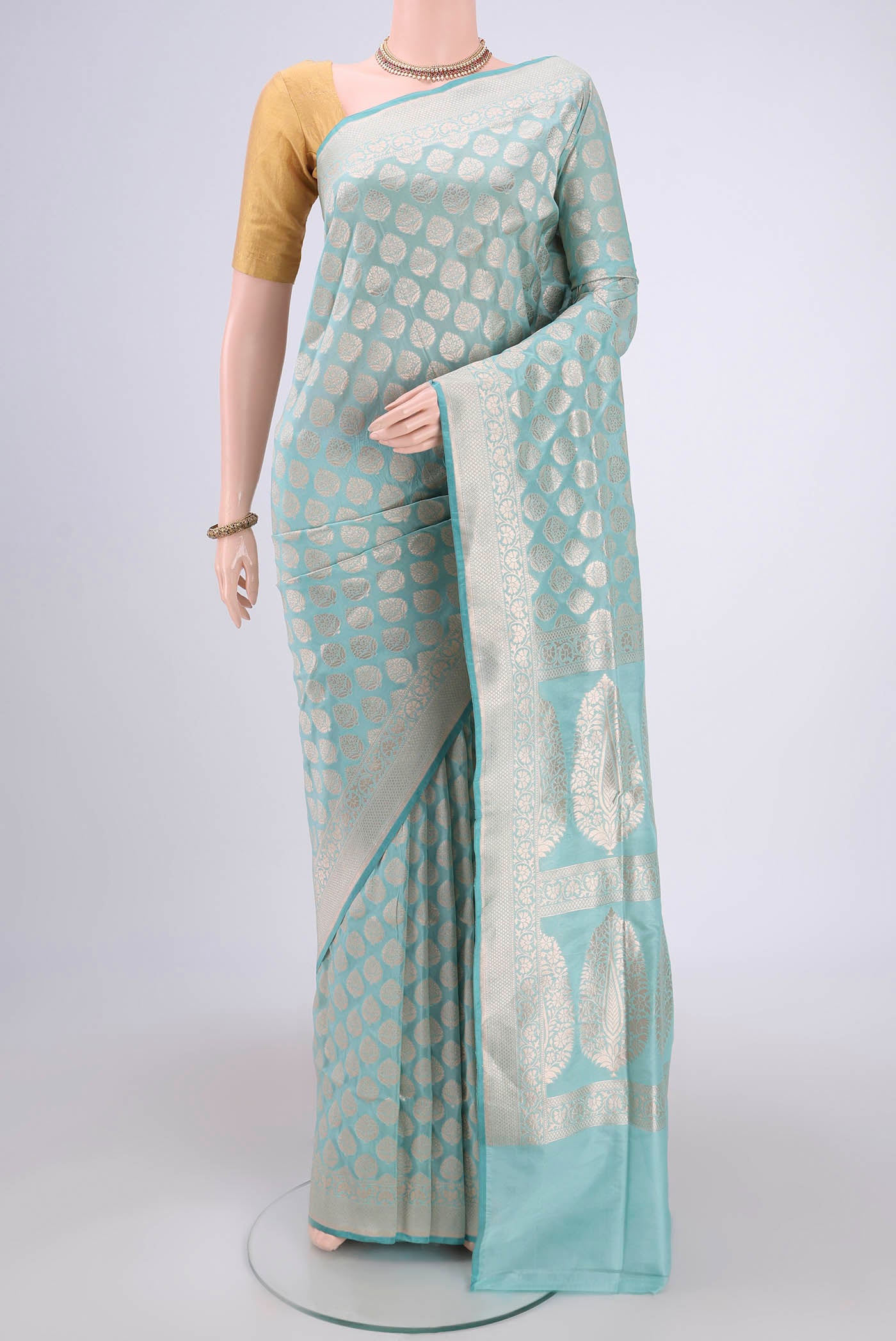 Sea Green Dual Tone Banarasi Silk Saree with Zari Butta on the body and Zari Border.  displayed on a mannequin
