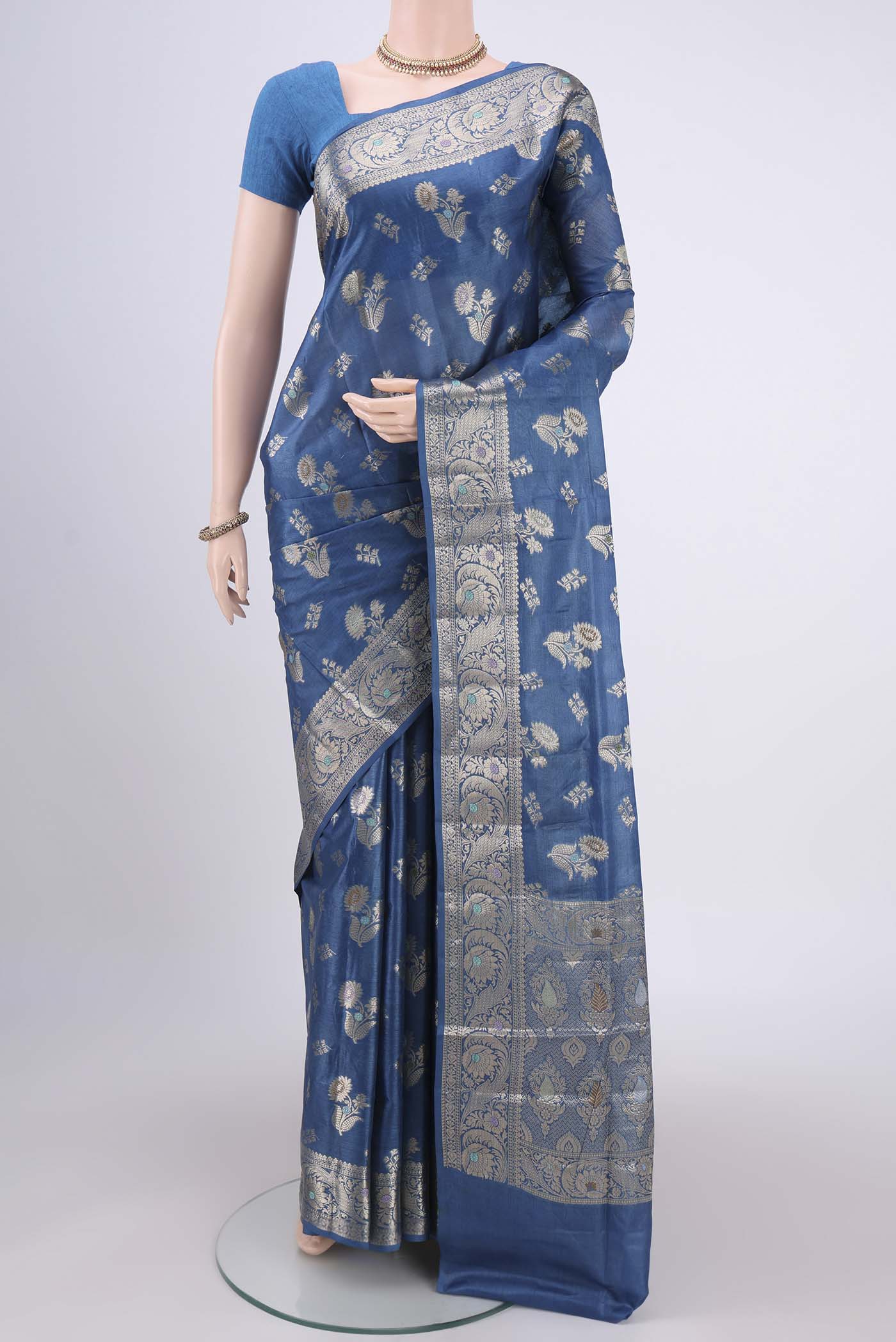 Blue Banarasi Tussar Silk Saree with Zari And Thread Butta on the body and Zari And Thread Border.  displayed on a mannequin