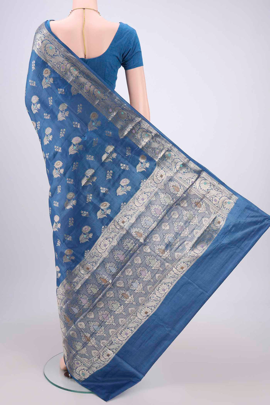 Flat view of Blue Banarasi Tussar Silk Saree with Zari And Thread Butta on the body and Zari And Thread Border. 