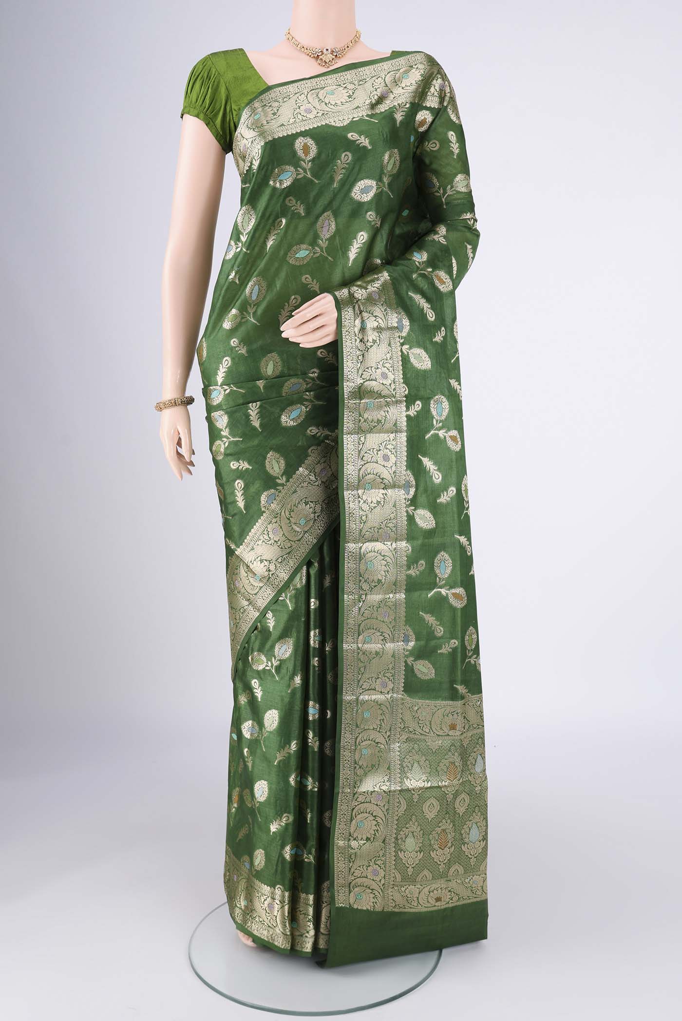 Green Banarasi Tussar Silk Saree with Zari And Thread Butta on the body and Zari Border.  displayed on a mannequin