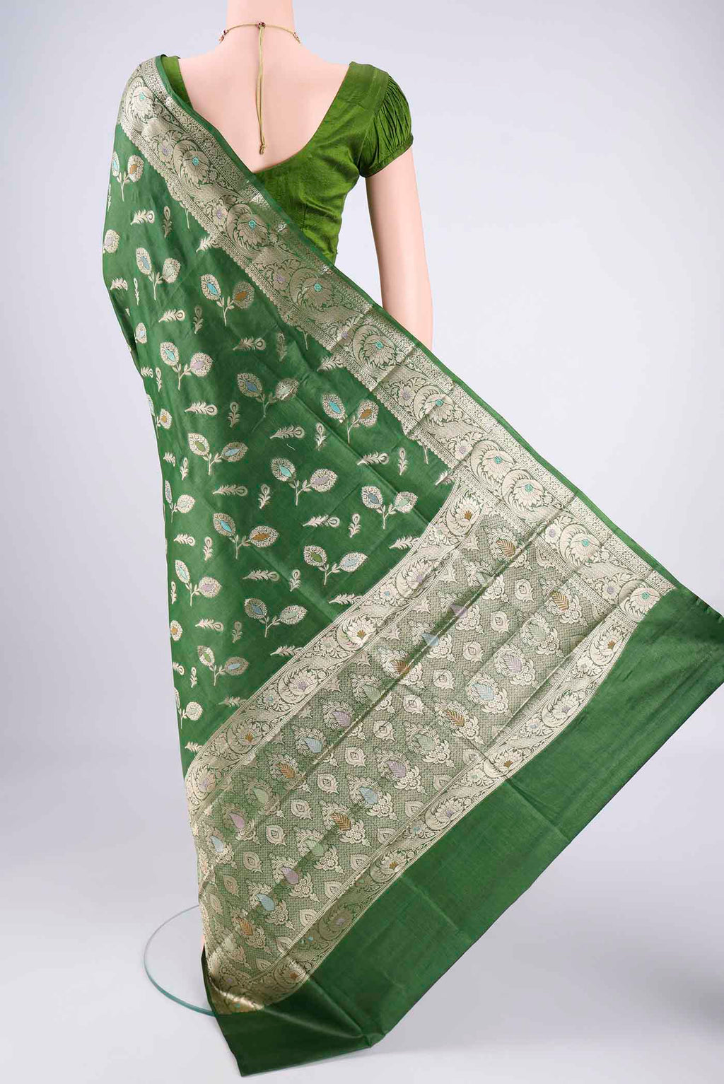 Flat view of Green Banarasi Tussar Silk Saree with Zari And Thread Butta on the body and Zari Border. 