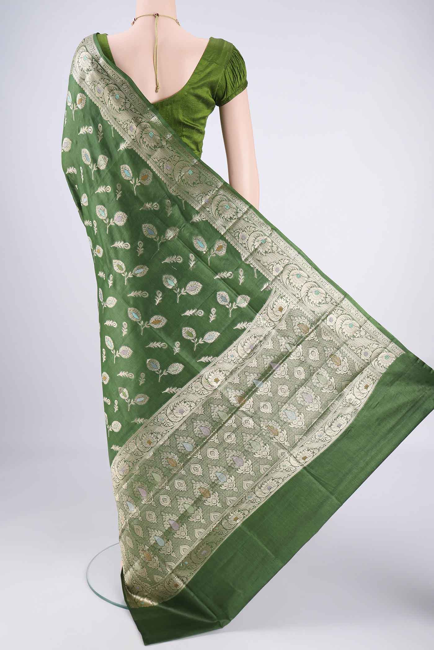 Flat view of Green Banarasi Tussar Silk Saree with Zari And Thread Butta on the body and Zari Border. 