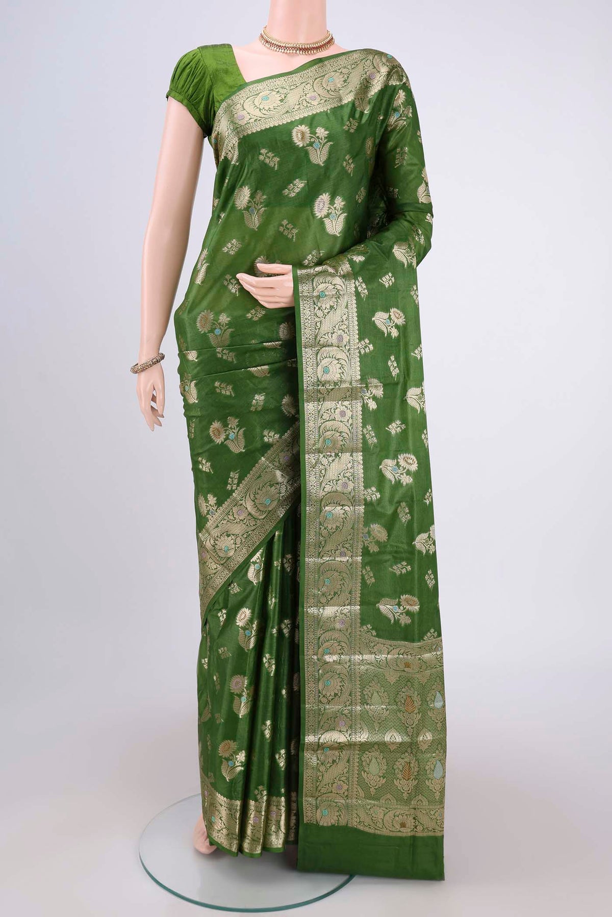 Green Banarasi Tussar Silk Saree with Zari And Thread Butta on the body and Zari And Thread Border.  displayed on a mannequin