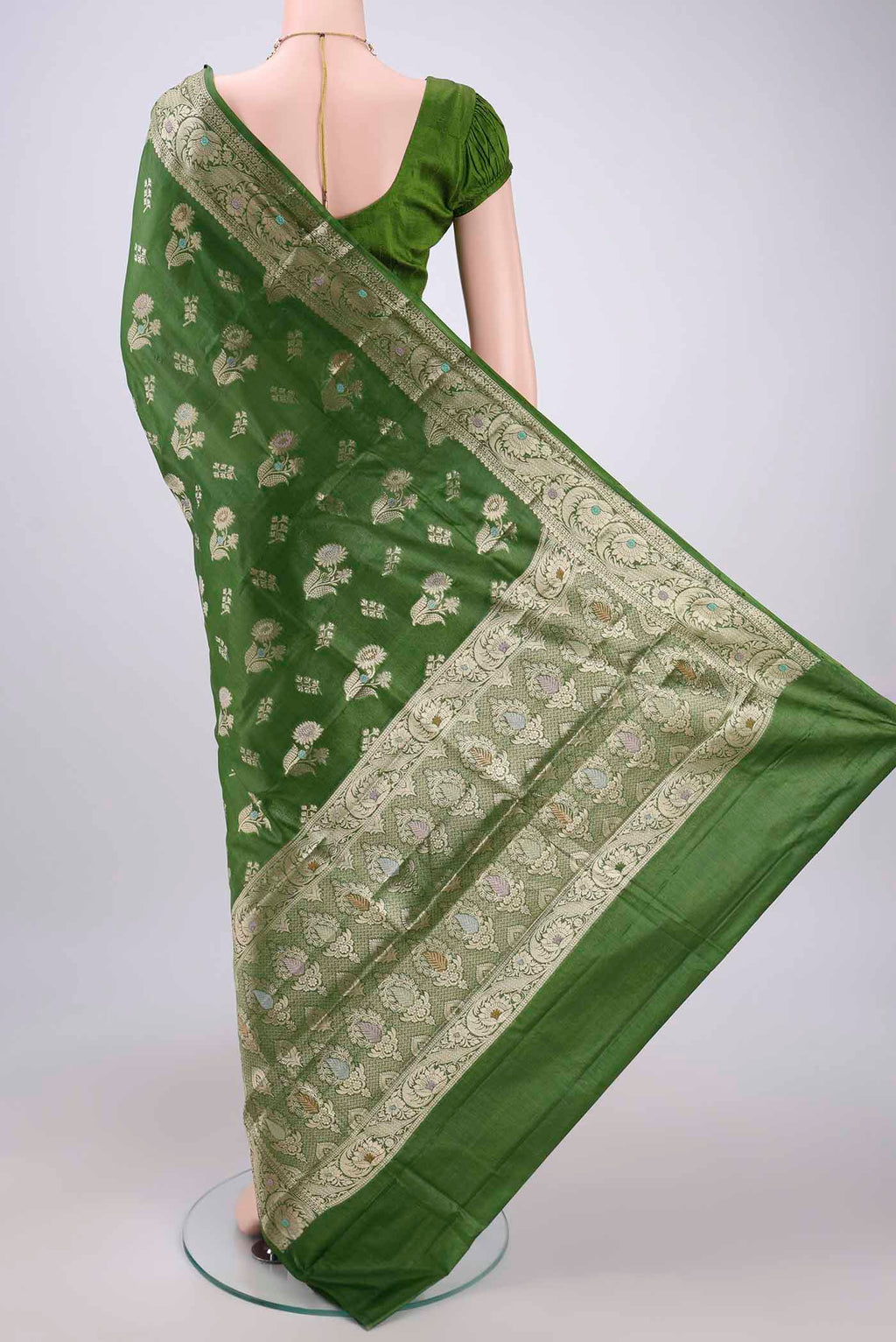 Flat view of Green Banarasi Tussar Silk Saree with Zari And Thread Butta on the body and Zari And Thread Border. 