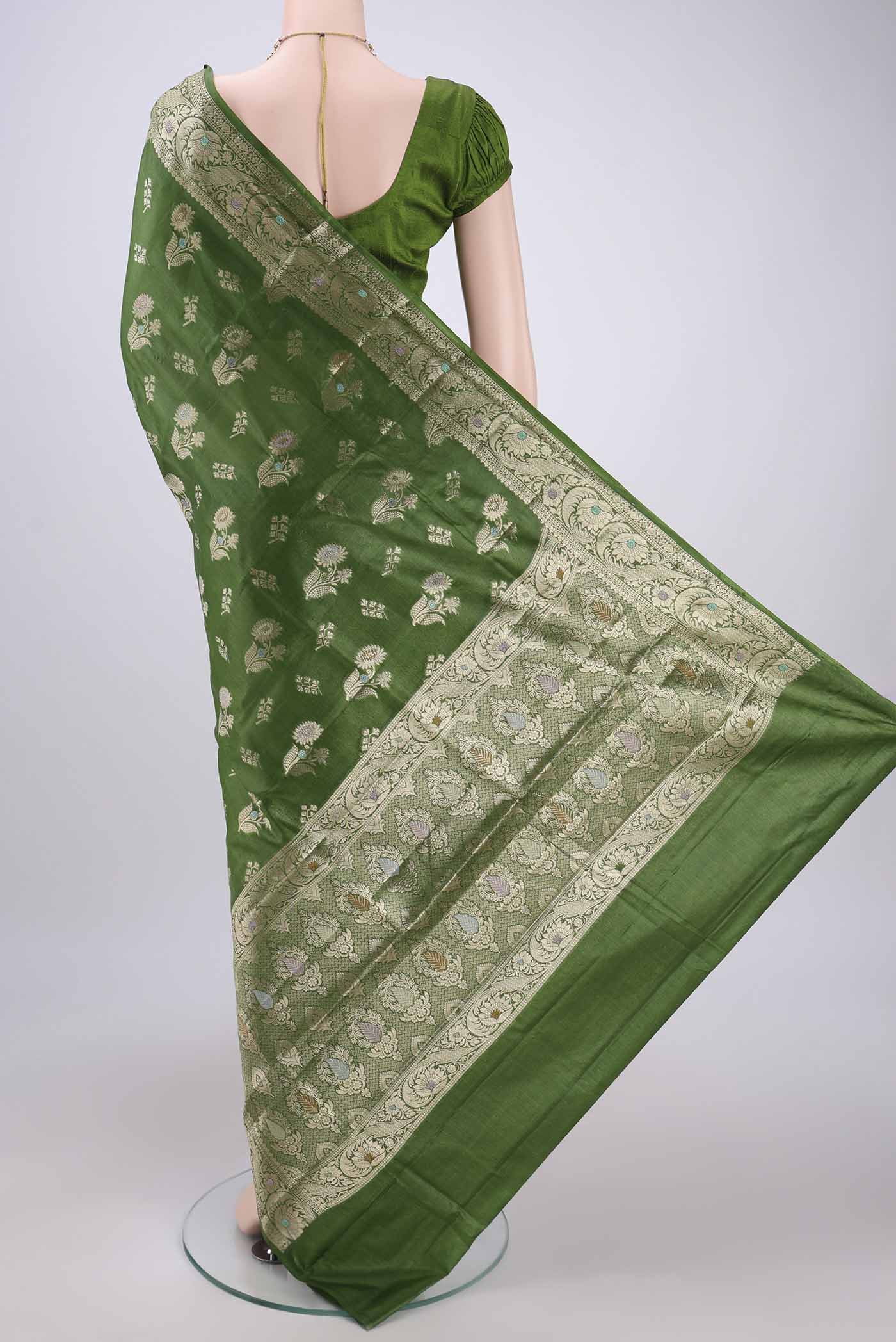 Flat view of Green Banarasi Tussar Silk Saree with Zari And Thread Butta on the body and Zari And Thread Border. 