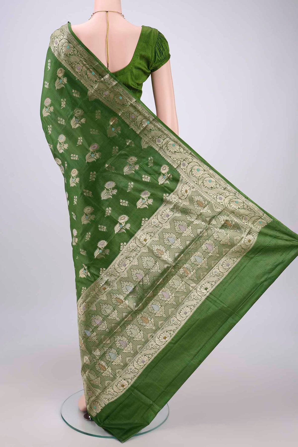 Flat view of Green Banarasi Tussar Silk Saree with Zari And Thread Butta on the body and Zari And Thread Border. 