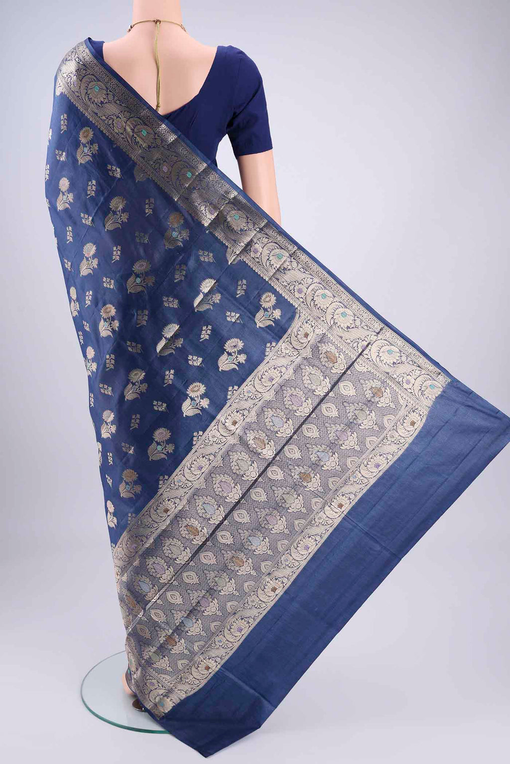Flat view of Blue Banarasi Tussar Silk Saree with Zari And Thread Butta on the body and Zari And Thread Border. 
