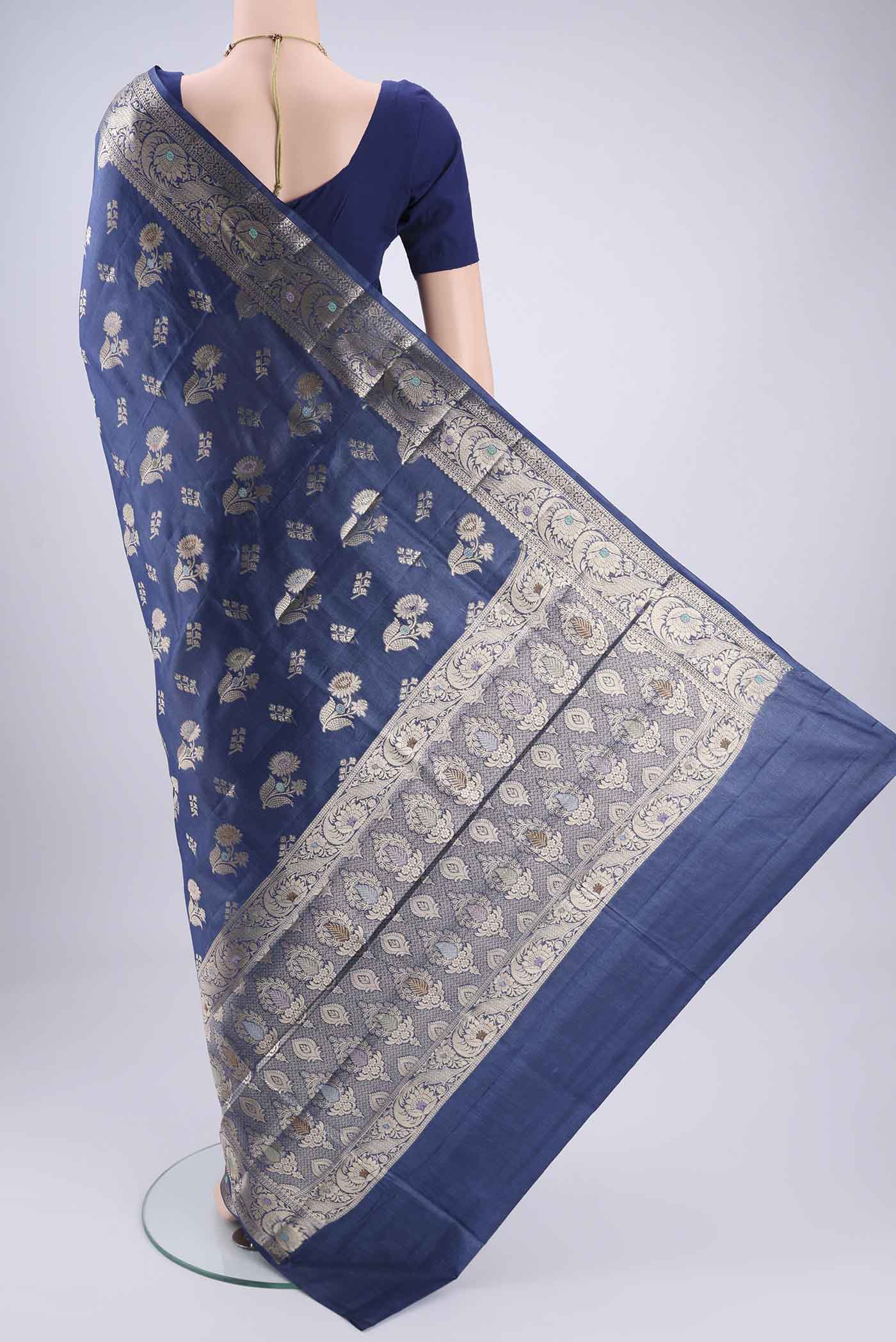Flat view of Blue Banarasi Tussar Silk Saree with Zari And Thread Butta on the body and Zari And Thread Border. 