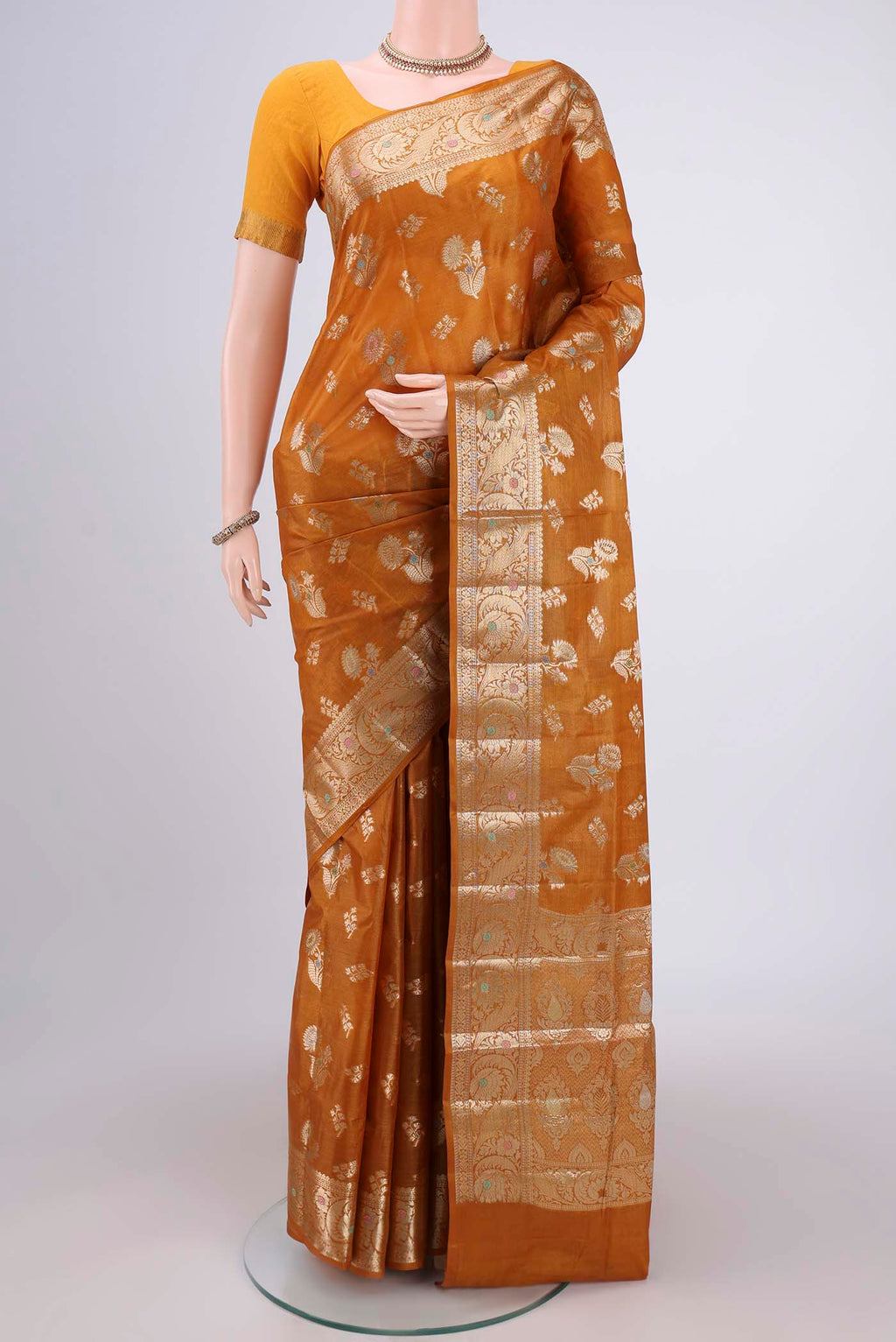 Mustard Banarasi Tussar Silk Saree with Zari Butta on the body and Zari Border.  displayed on a mannequin