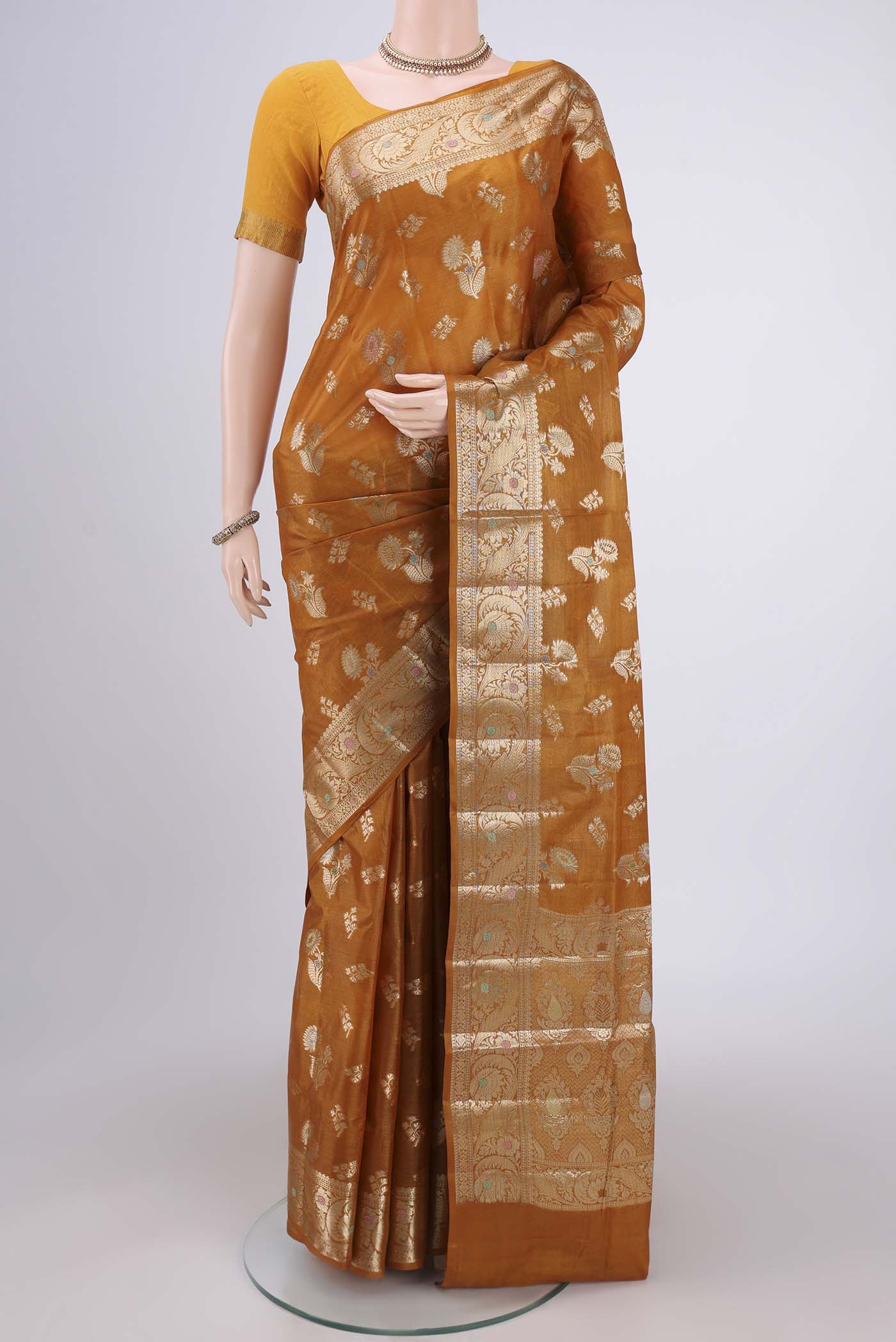 Mustard Banarasi Tussar Silk Saree with Zari Butta on the body and Zari Border.  displayed on a mannequin