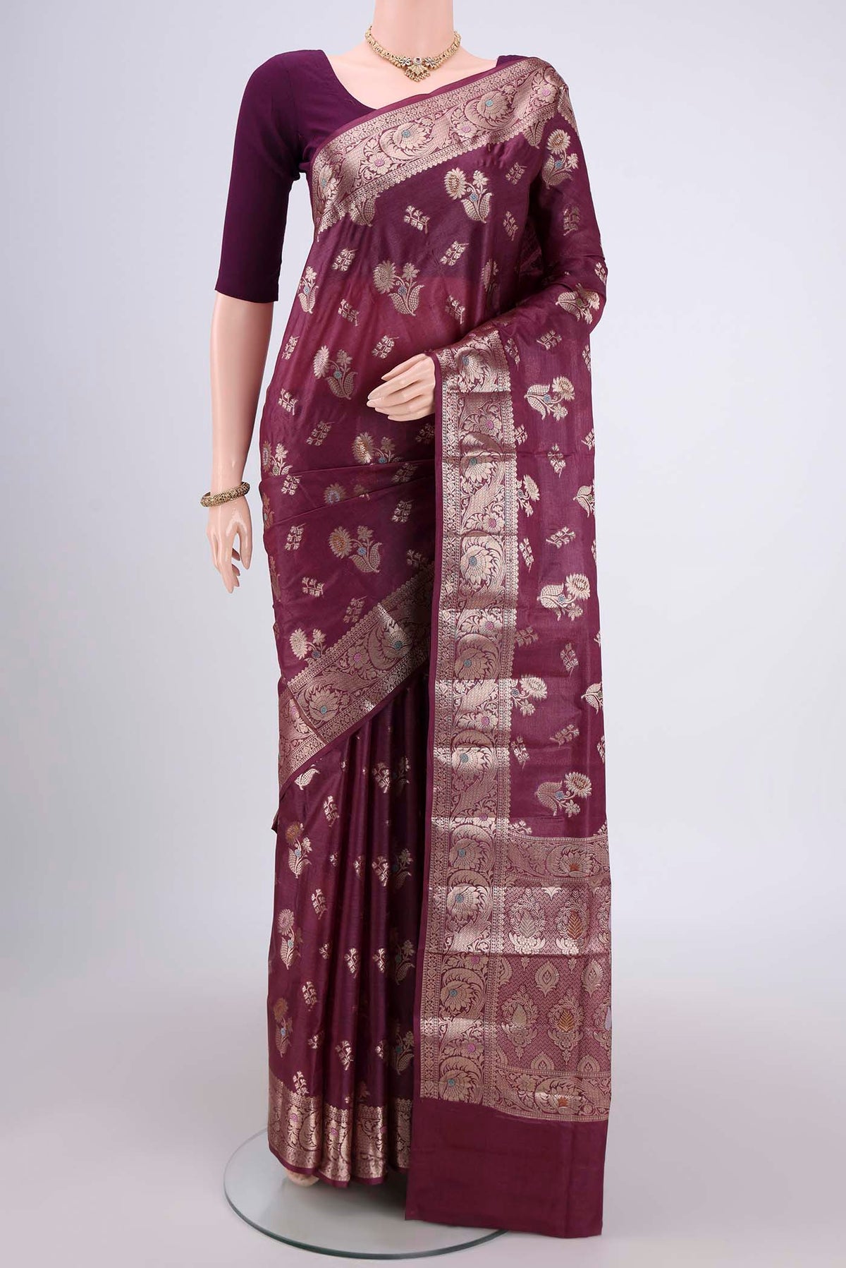 Burgundy Banarasi Tussar Silk Saree with Zari And Thread Butta on the body and Zari And Thread Border.  displayed on a mannequin