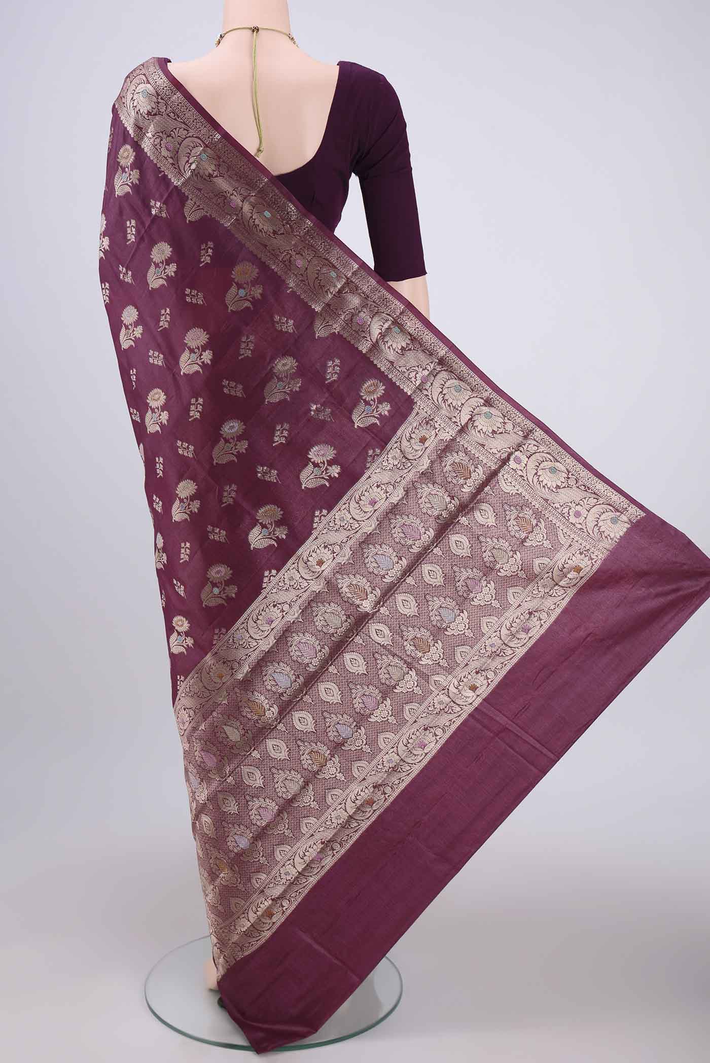 Flat view of Burgundy Banarasi Tussar Silk Saree with Zari And Thread Butta on the body and Zari And Thread Border. 