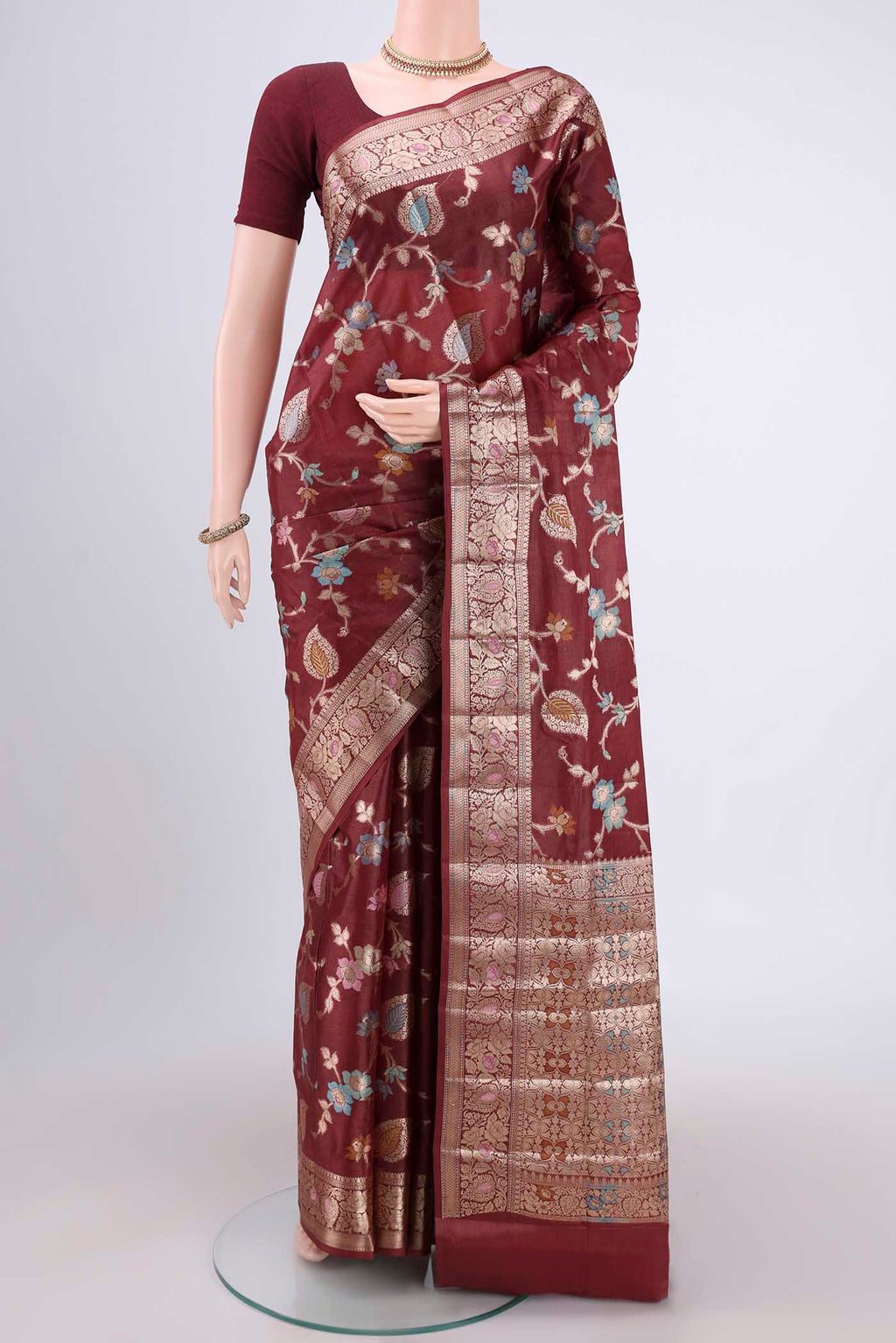 Brown Banarasi Tussar Silk Saree with Zari And Thread Butta on the body and Zari And Thread Border.  displayed on a mannequin