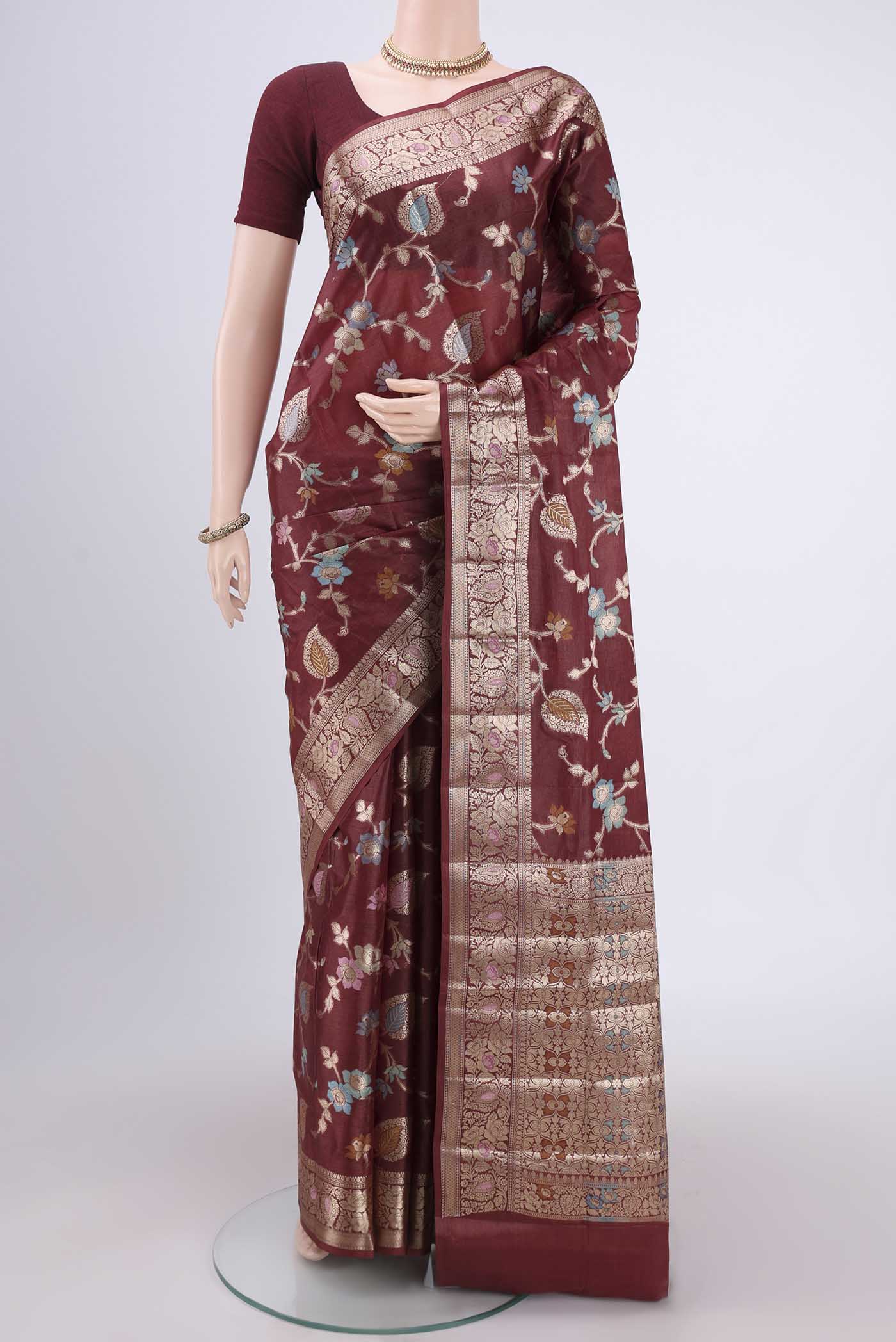 Brown Banarasi Tussar Silk Saree with Zari And Thread Butta on the body and Zari And Thread Border.  displayed on a mannequin