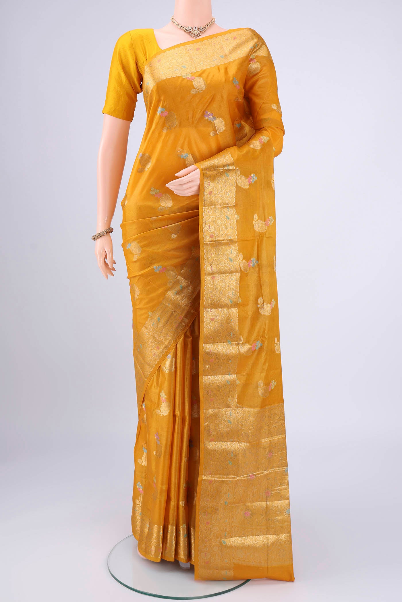 Mustard Banarasi Tussar Silk Saree with Zari And Thread Butta on the body and Zari And Thread Border.  displayed on a mannequin