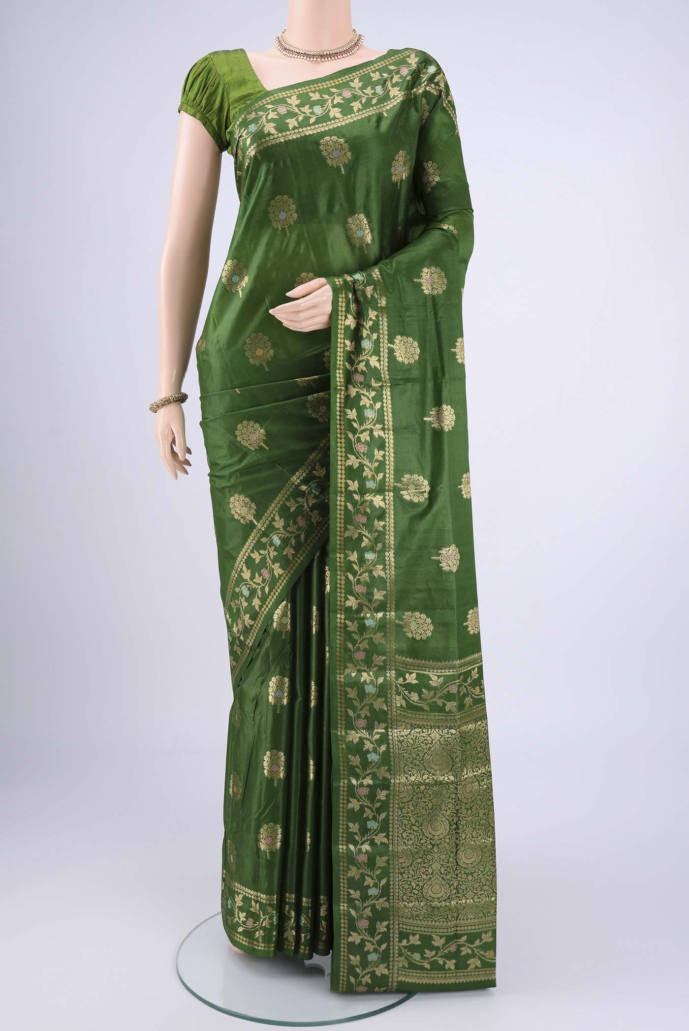 Green Banarasi Tussar Silk Saree with Zari And Thread Butta on the body and Zari And Thread Border.  displayed on a mannequin
