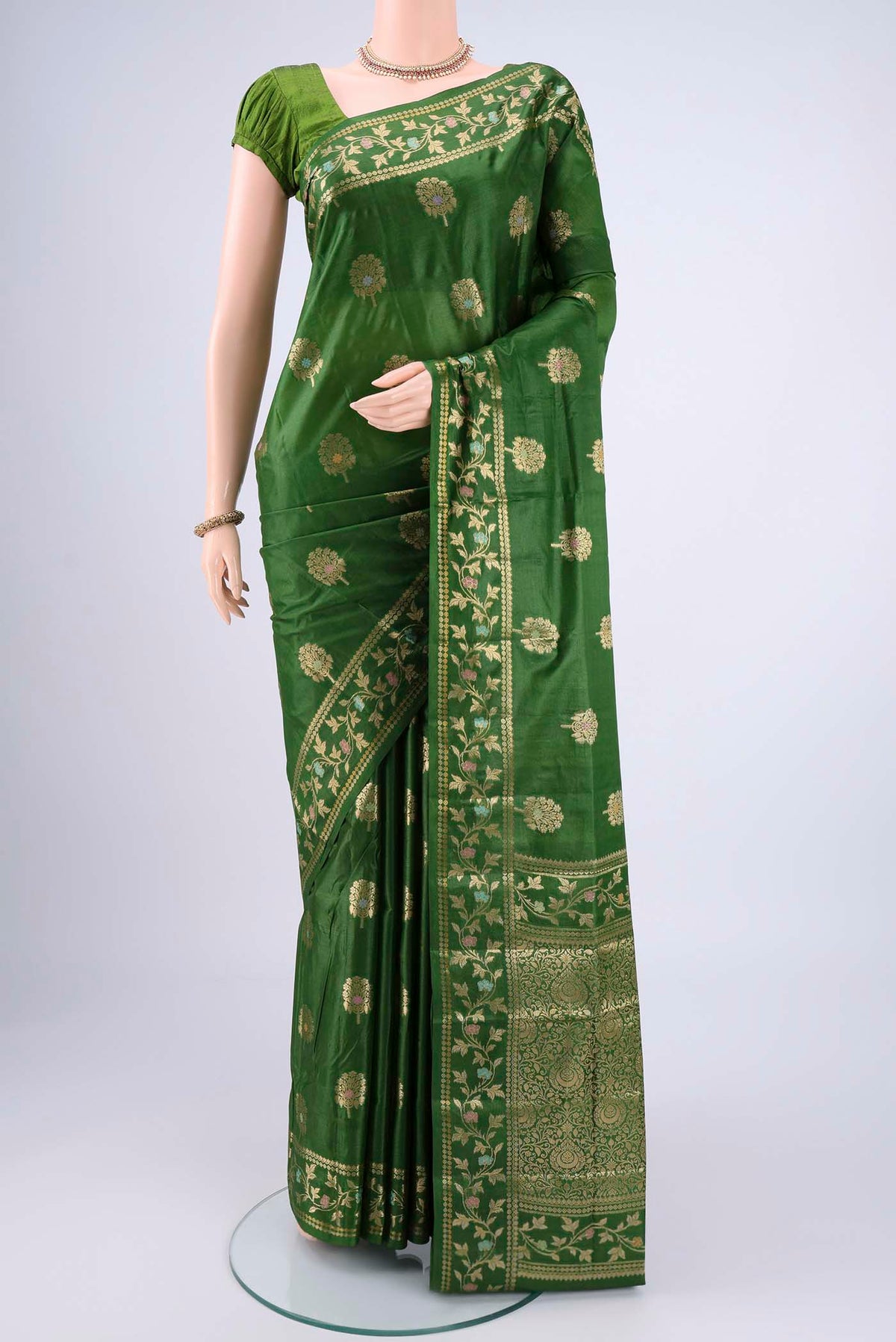 Green Banarasi Tussar Silk Saree with Zari And Thread Butta on the body and Zari And Thread Border.  displayed on a mannequin