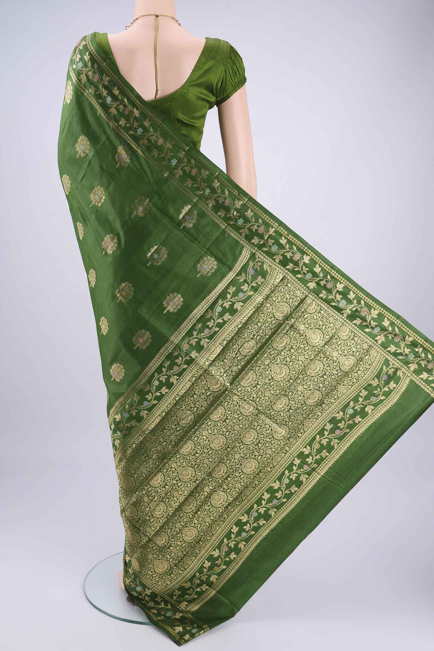 Flat view of Green Banarasi Tussar Silk Saree with Zari And Thread Butta on the body and Zari And Thread Border. 