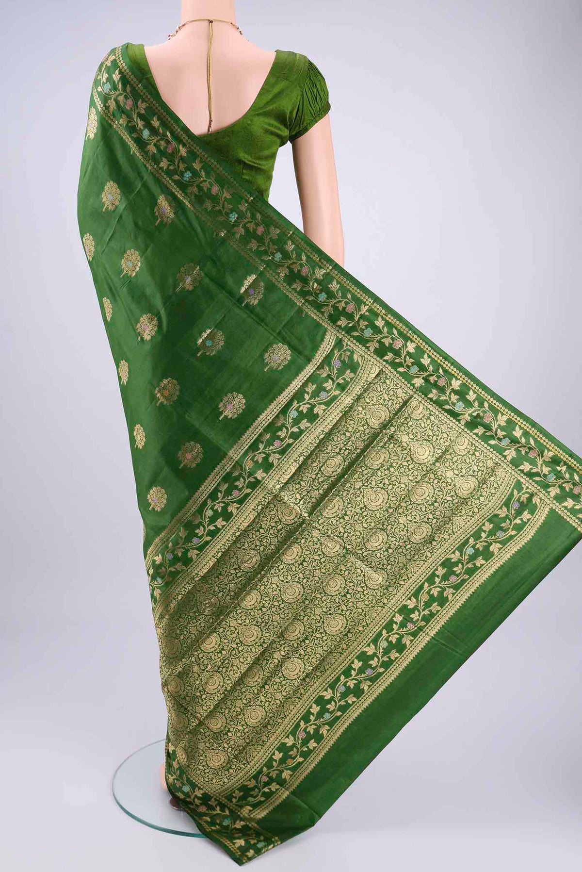 Flat view of Green Banarasi Tussar Silk Saree with Zari And Thread Butta on the body and Zari And Thread Border. 