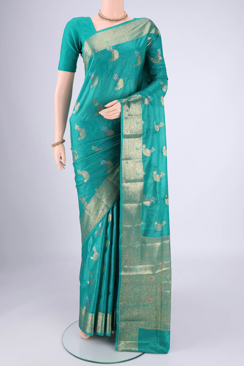 Turquoise Banarasi Tussar Silk Saree with Zari And Thread Butta on the body and Zari And Thread Border.  displayed on a mannequin