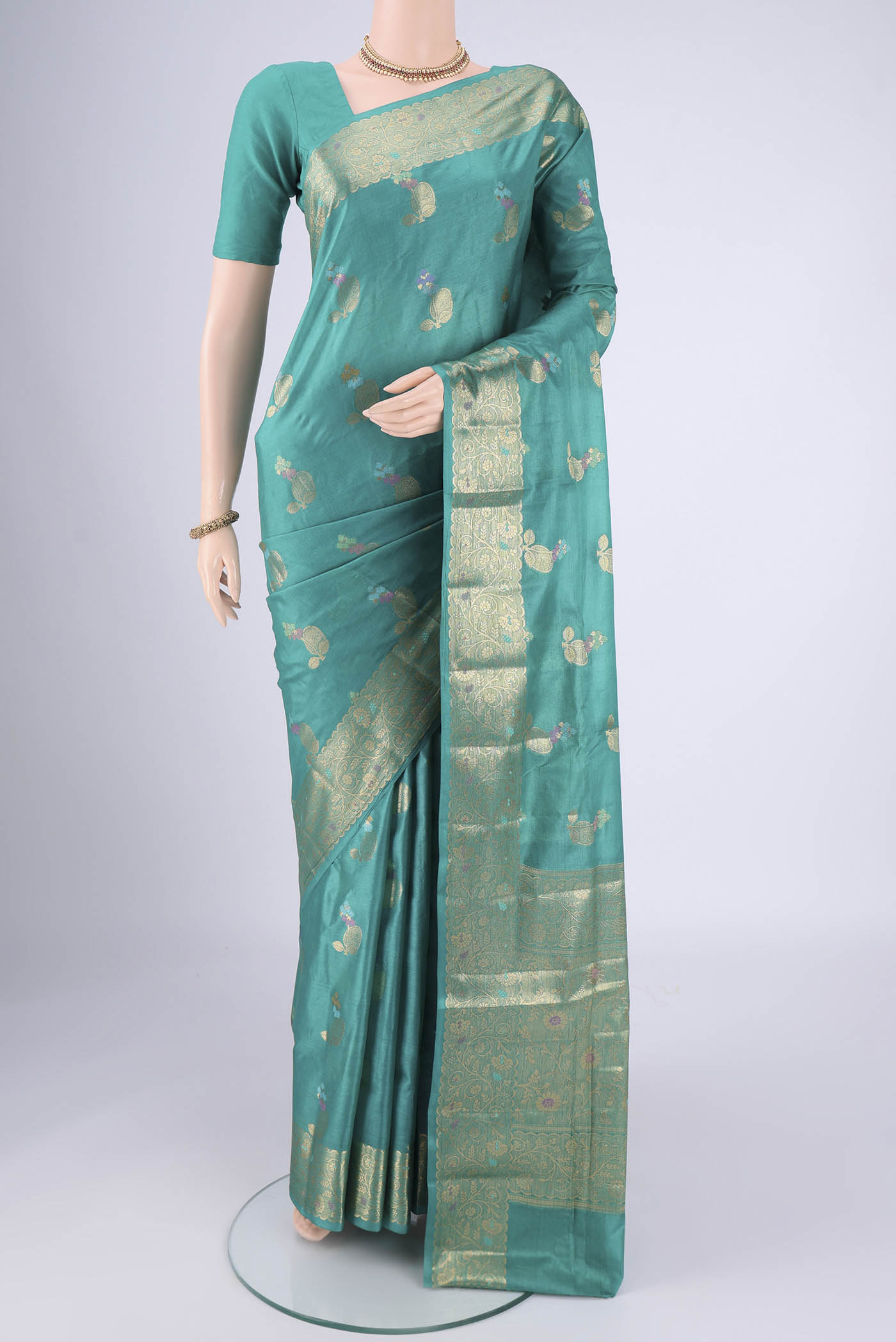 Turquoise Banarasi Tussar Silk Saree with Zari And Thread Butta on the body and Zari And Thread Border.  displayed on a mannequin