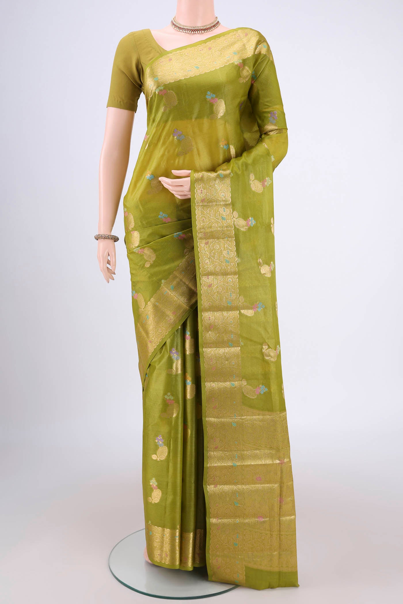 Light Green Banarasi Tussar Silk Saree with Zari And Thread Butta on the body and Zari And Thread Border.  displayed on a mannequin