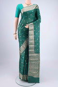 Green Banarasi Tussar Silk Saree with Zari Butta on the body and Zari And Thread Border.  displayed on a mannequin