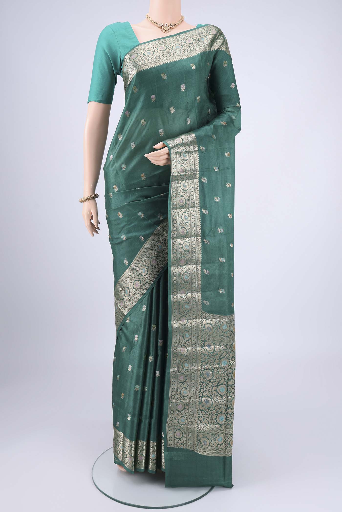 Green Banarasi Tussar Silk Saree with Zari Butta on the body and Zari And Thread Border.  displayed on a mannequin