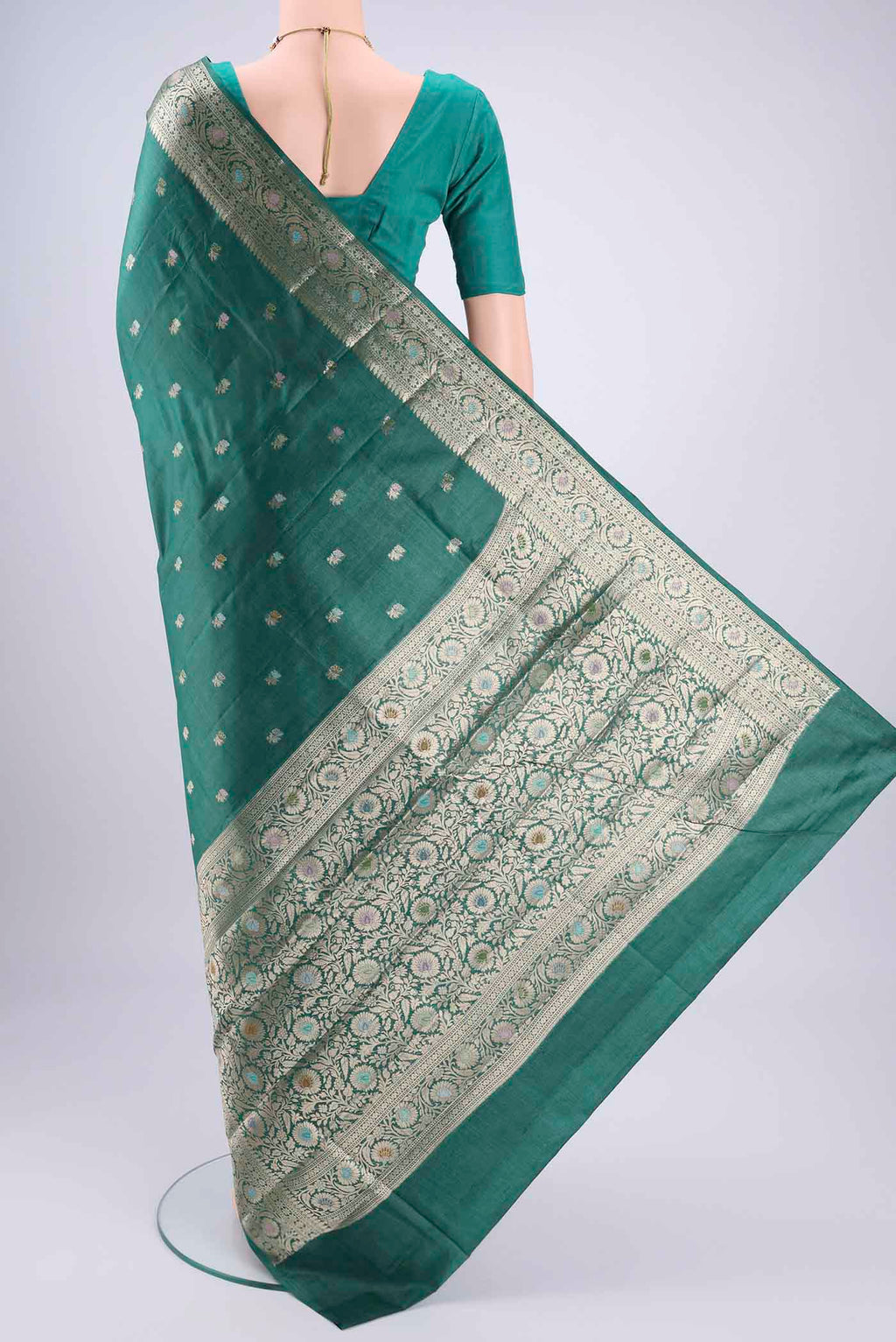 Flat view of Green Banarasi Tussar Silk Saree with Zari Butta on the body and Zari And Thread Border. 