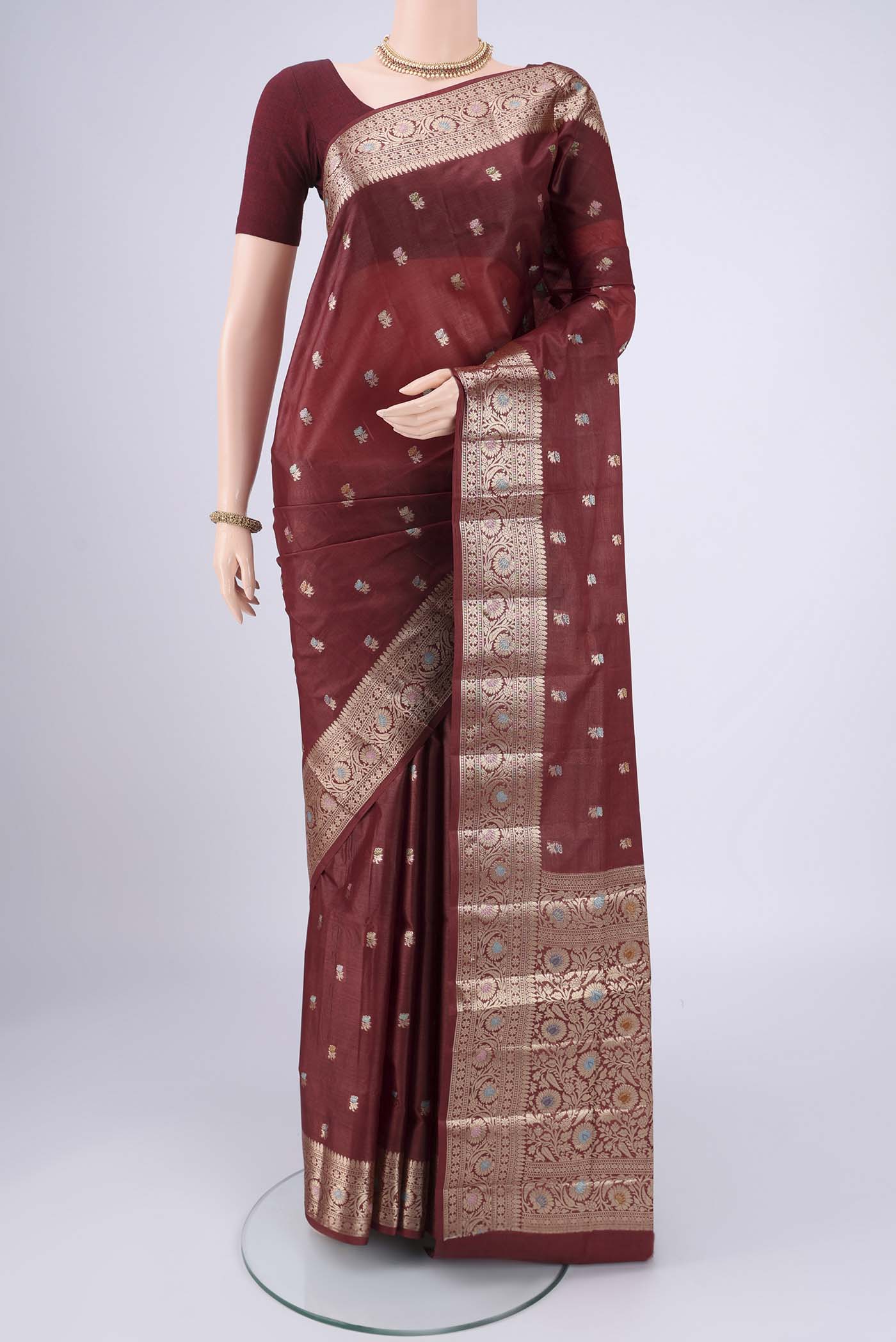 Brown Banarasi Tussar Silk Saree with Zari And Thread Butta on the body and Zari And Thread Border.  displayed on a mannequin