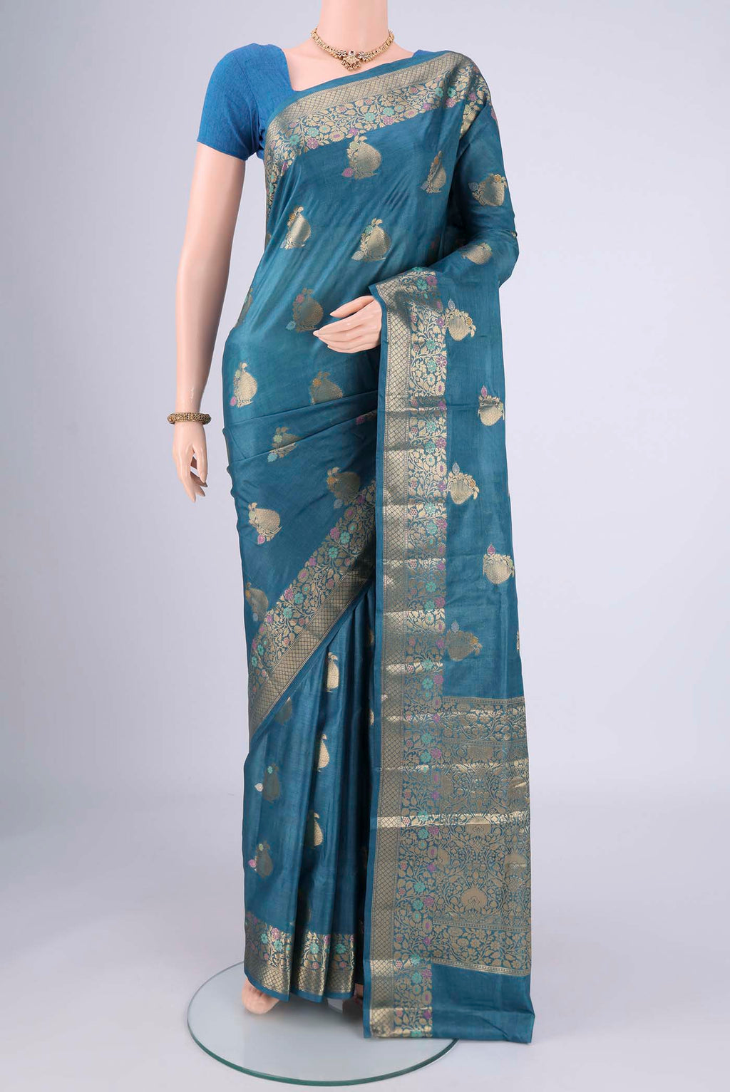 Blue Banarasi Tussar Silk Saree with Zari And Thread Butta on the body and Zari And Thread Border.  displayed on a mannequin