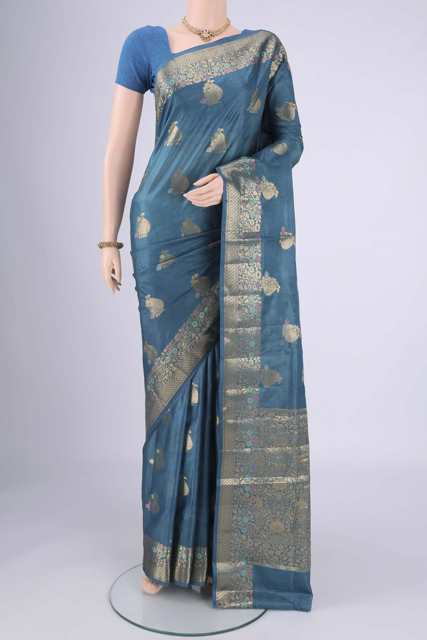 Blue Banarasi Tussar Silk Saree with Zari And Thread Butta on the body and Zari And Thread Border.  displayed on a mannequin