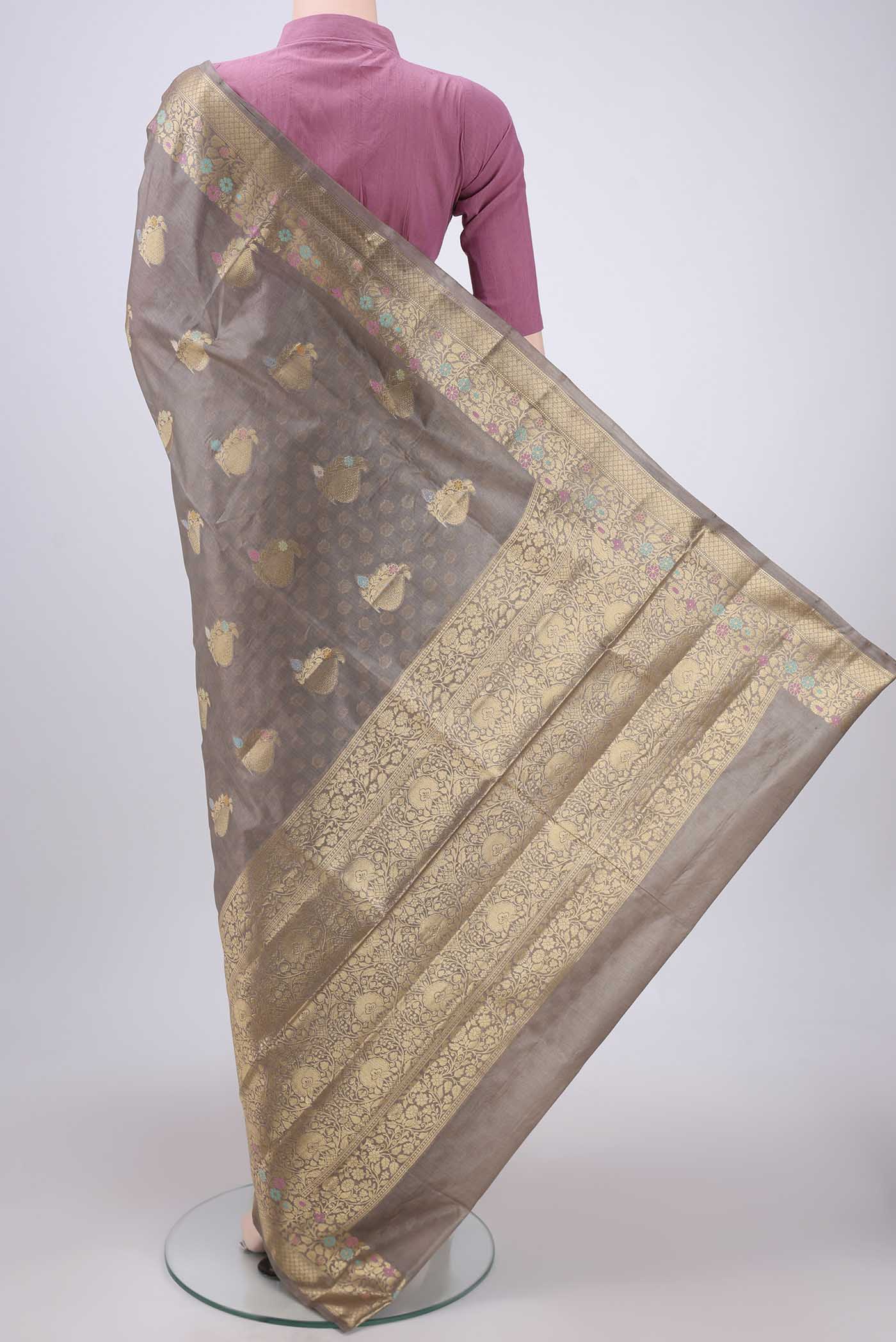 Flat view of Beige Banarasi Tussar Silk Saree with Zari And Thread Butta on the body and Zari And Thread Border. 