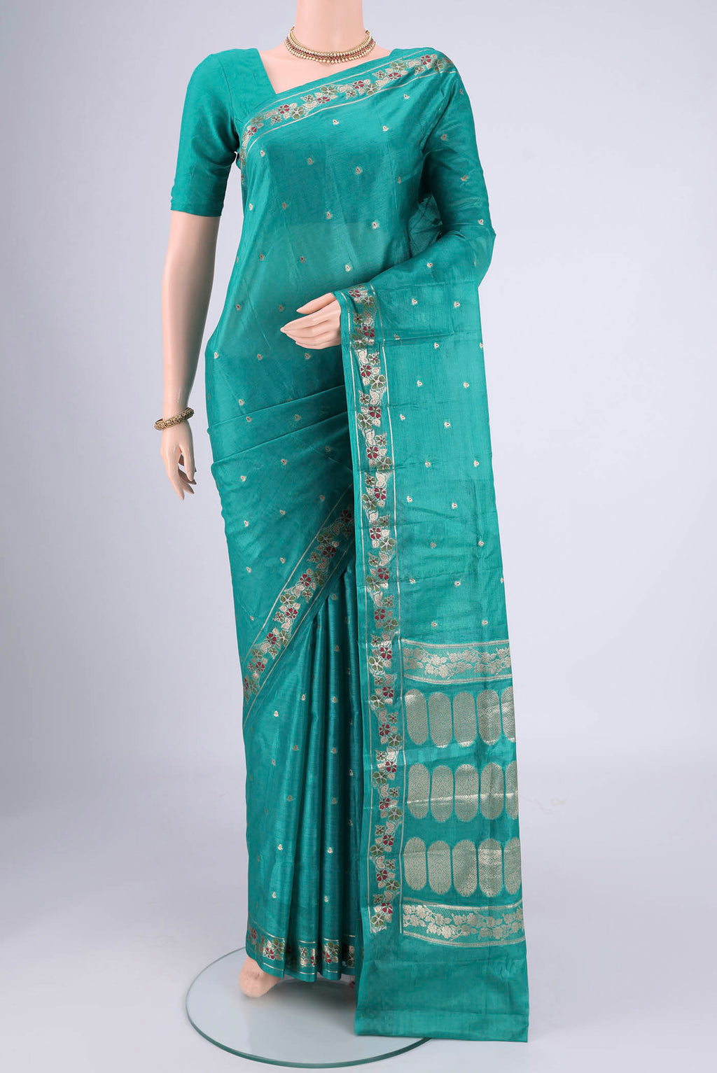 Turquoise Banarasi Tussar Silk Saree with Zari And Thread Butta on the body and Zari And Thread Border.  displayed on a mannequin