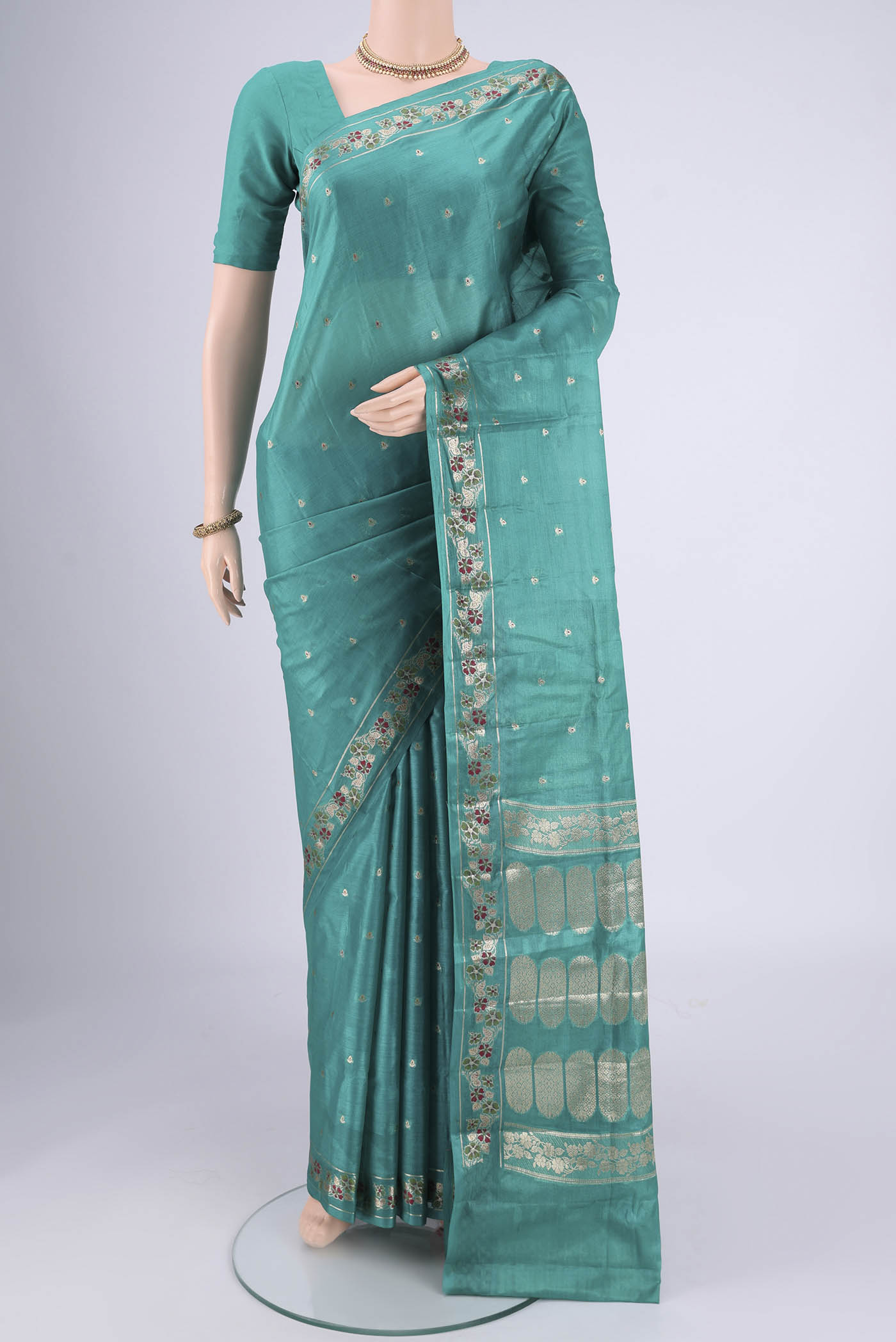 Turquoise Banarasi Tussar Silk Saree with Zari And Thread Butta on the body and Zari And Thread Border.  displayed on a mannequin