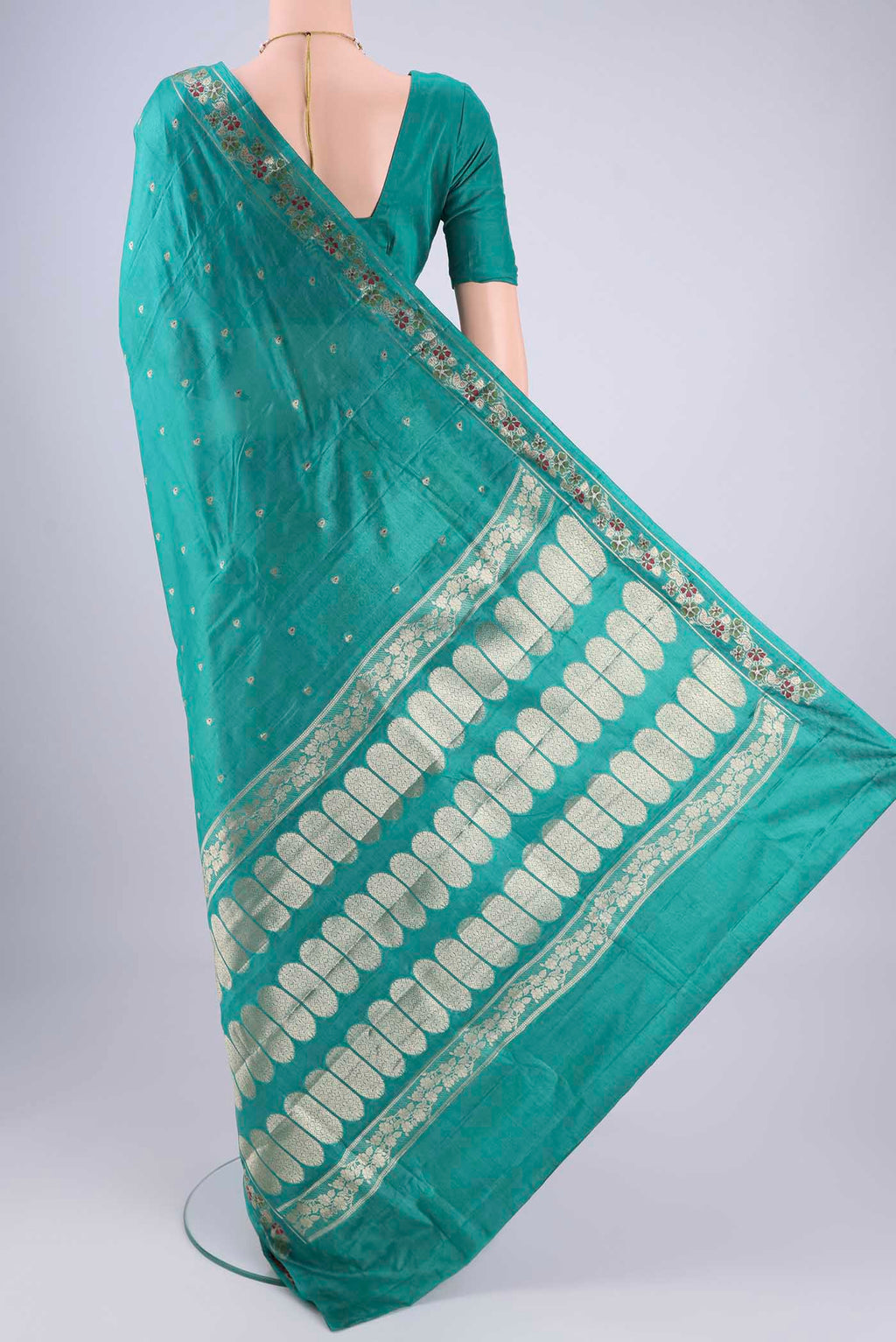 Flat view of Turquoise Banarasi Tussar Silk Saree with Zari And Thread Butta on the body and Zari And Thread Border. 