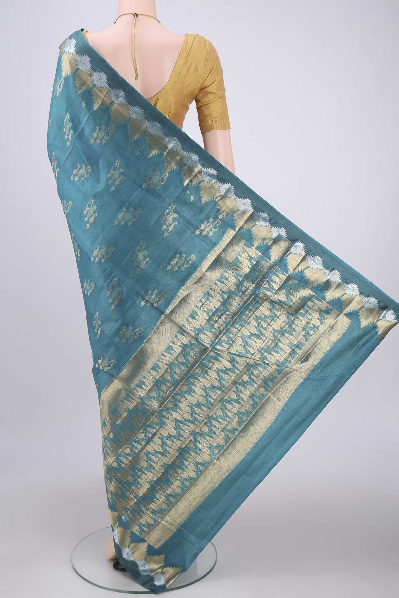 Flat view of Blue Banarasi Tussar Silk Saree with Zari Butta on the body and Zari Border. 