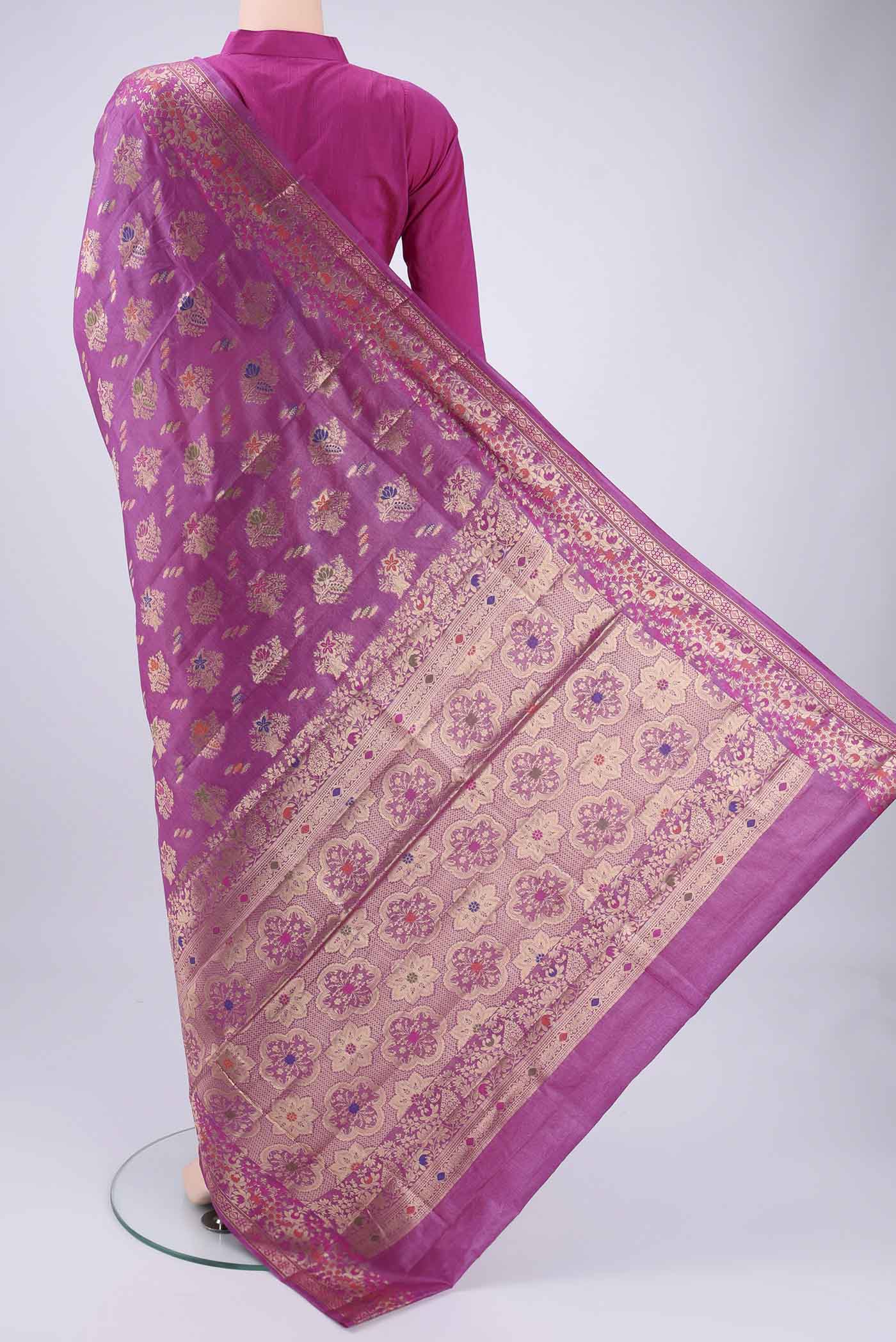 Flat view of Magenta Banarasi Tussar Silk Saree with Zari Brocade on the body and Zari And Thread Border. 