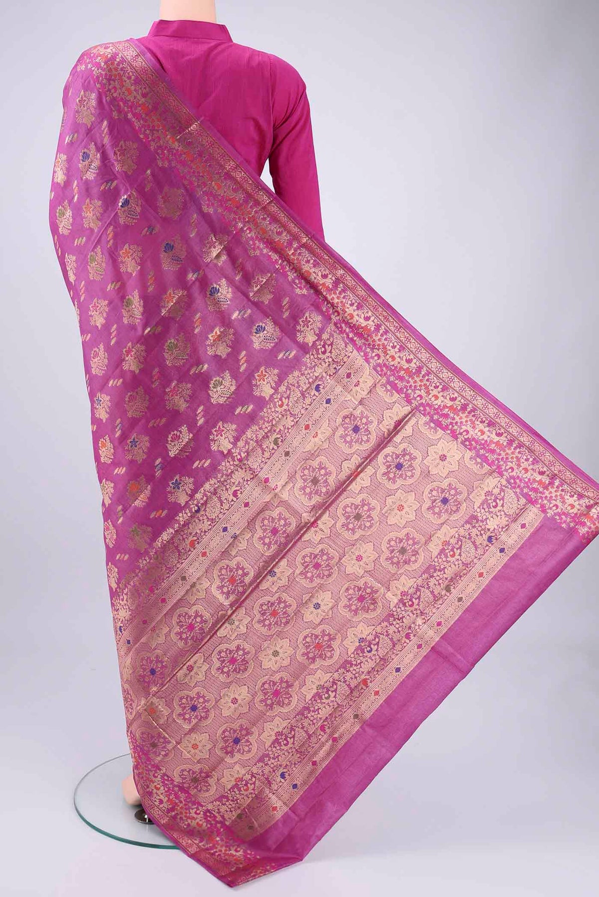 Flat view of Magenta Banarasi Tussar Silk Saree with Zari Brocade on the body and Zari And Thread Border. 